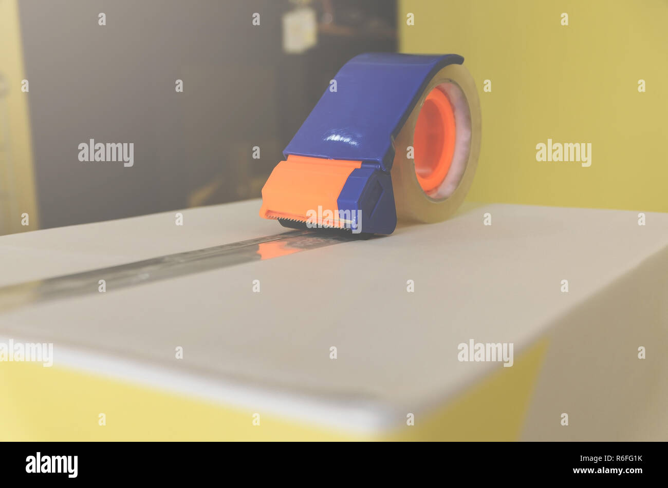 Close up of parcel box with scissors and scotch tape cutter