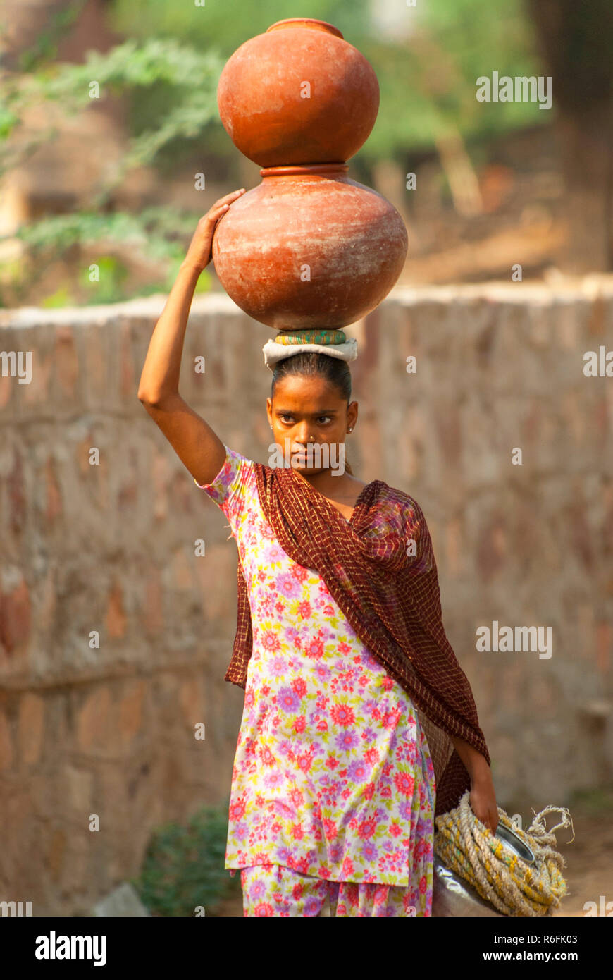 Balancing bucket on head hires stock photography and images Alamy