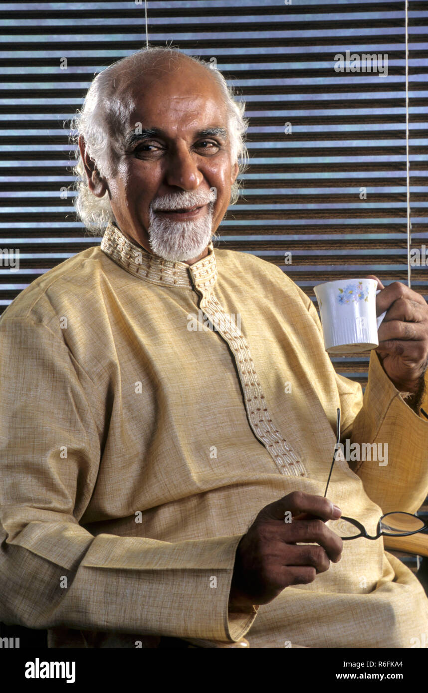 Old Man holding Cup Stock Photo