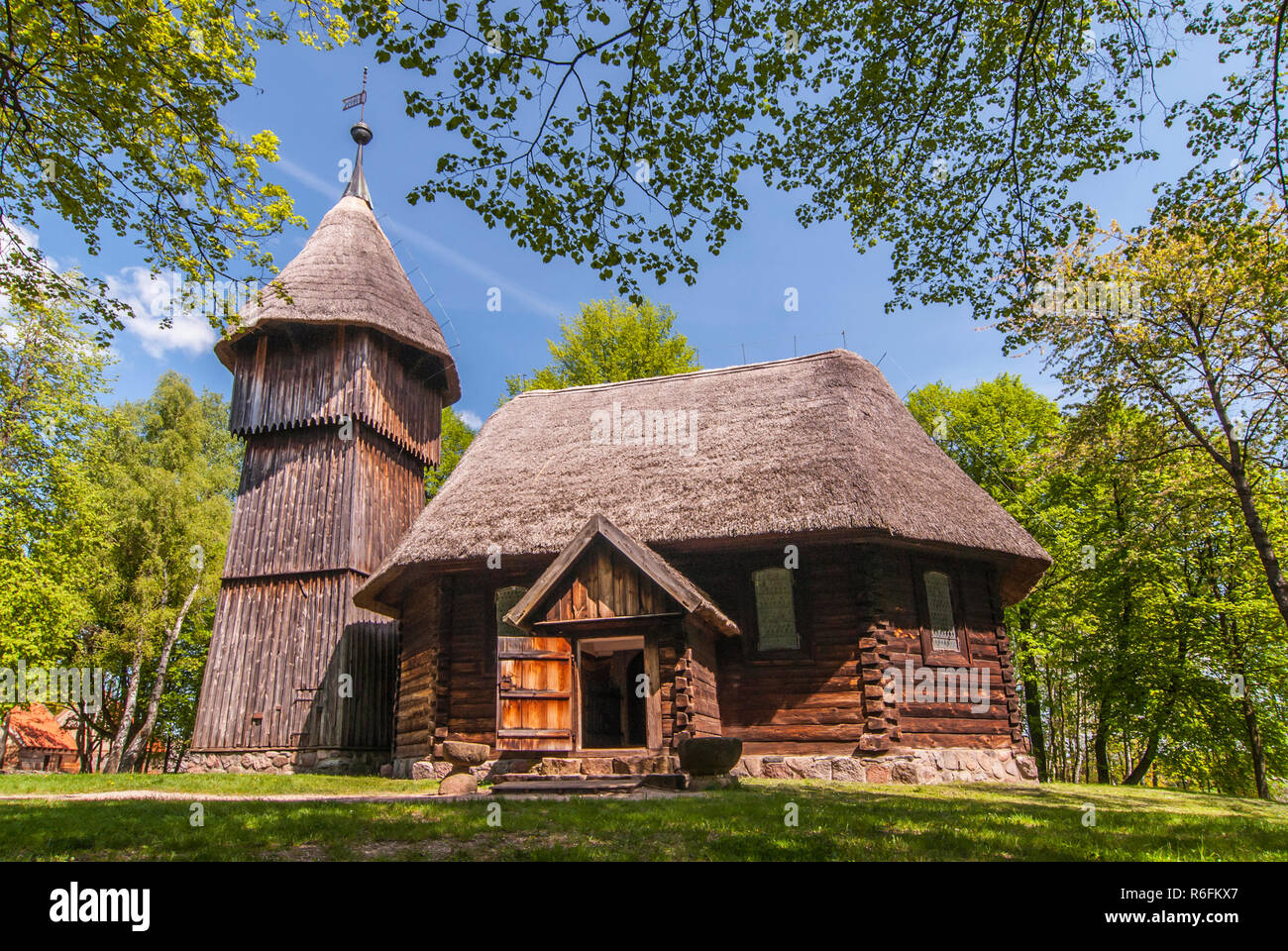 Old Wooden Evangelic Church With And Wooden Belfry, Both From Masuria Region, Ethnographic Park In Olsztynek, Poland Stock Photo