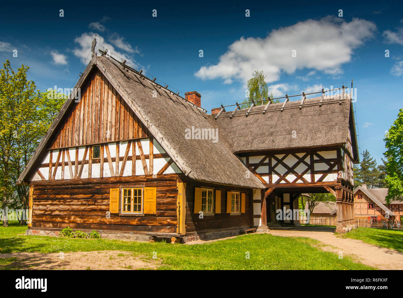 Replica Of Early 20Th Century Hut With Arcade Extension, Partly Half-Timbered Wall And Thatched Roof From Masuria Region, The Folk Architecture Museum Stock Photo