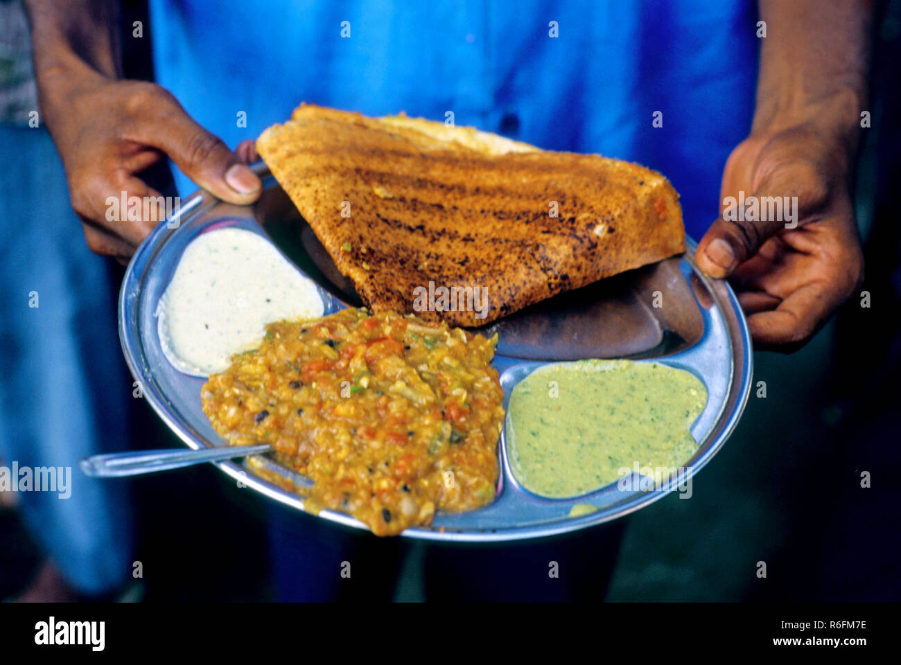 dosa with vegetable and chatni in roadside dosa stall, india Stock Photo