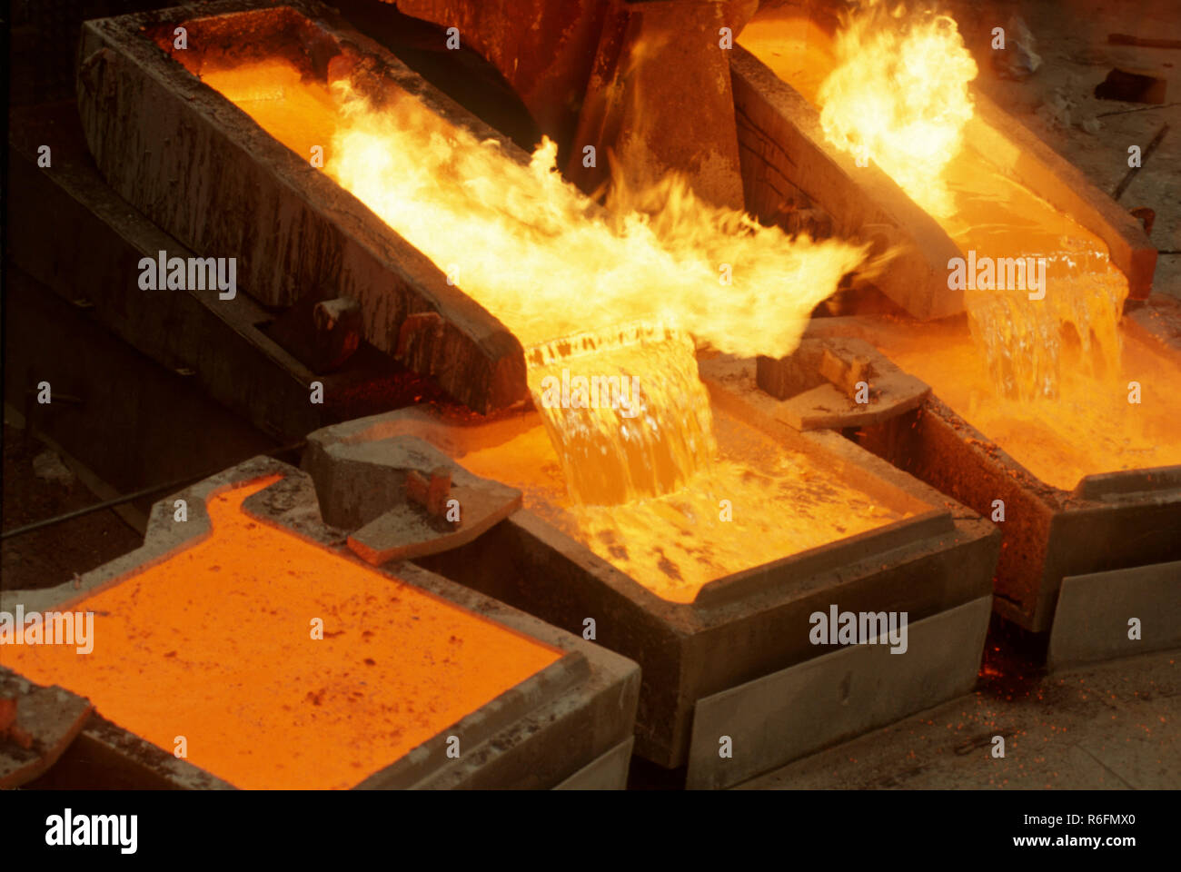 Pouring molten yellow copper into casts Stock Photo