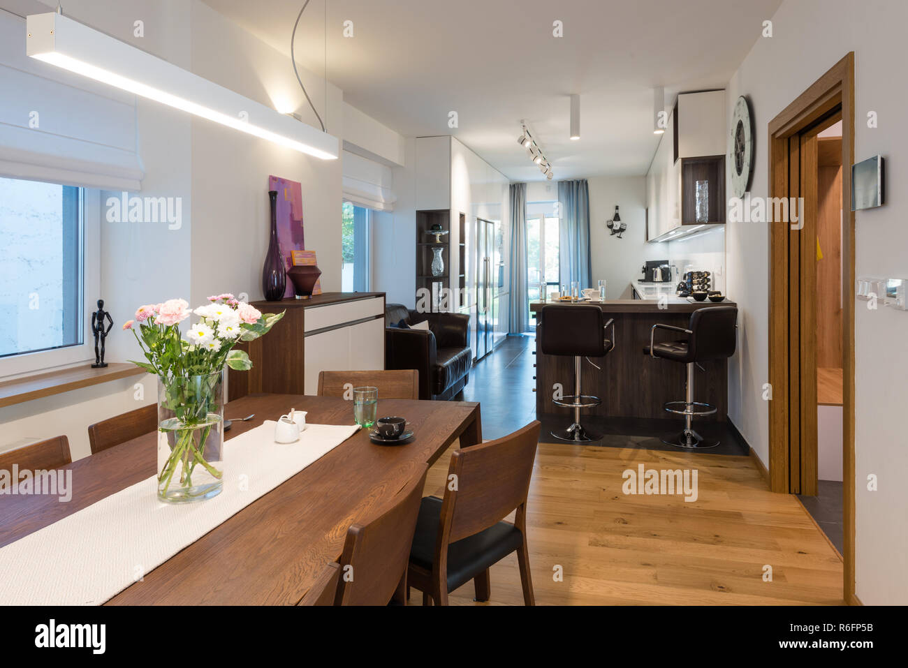 Dining table next to kitchen in modern house Stock Photo Alamy