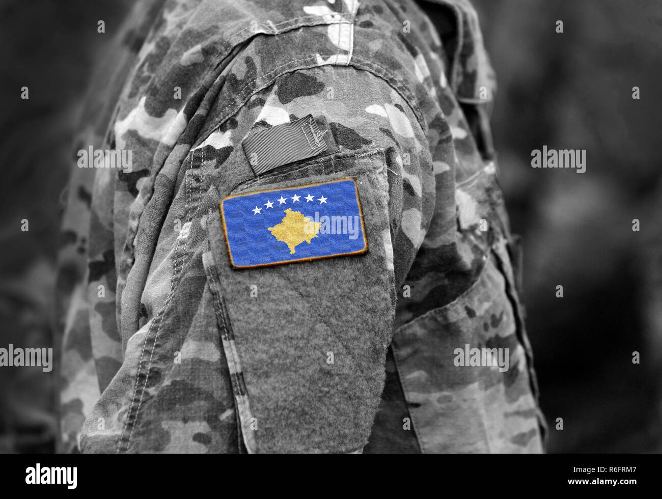 Flag of Kosovo on soldiers arm (collage). Stock Photo