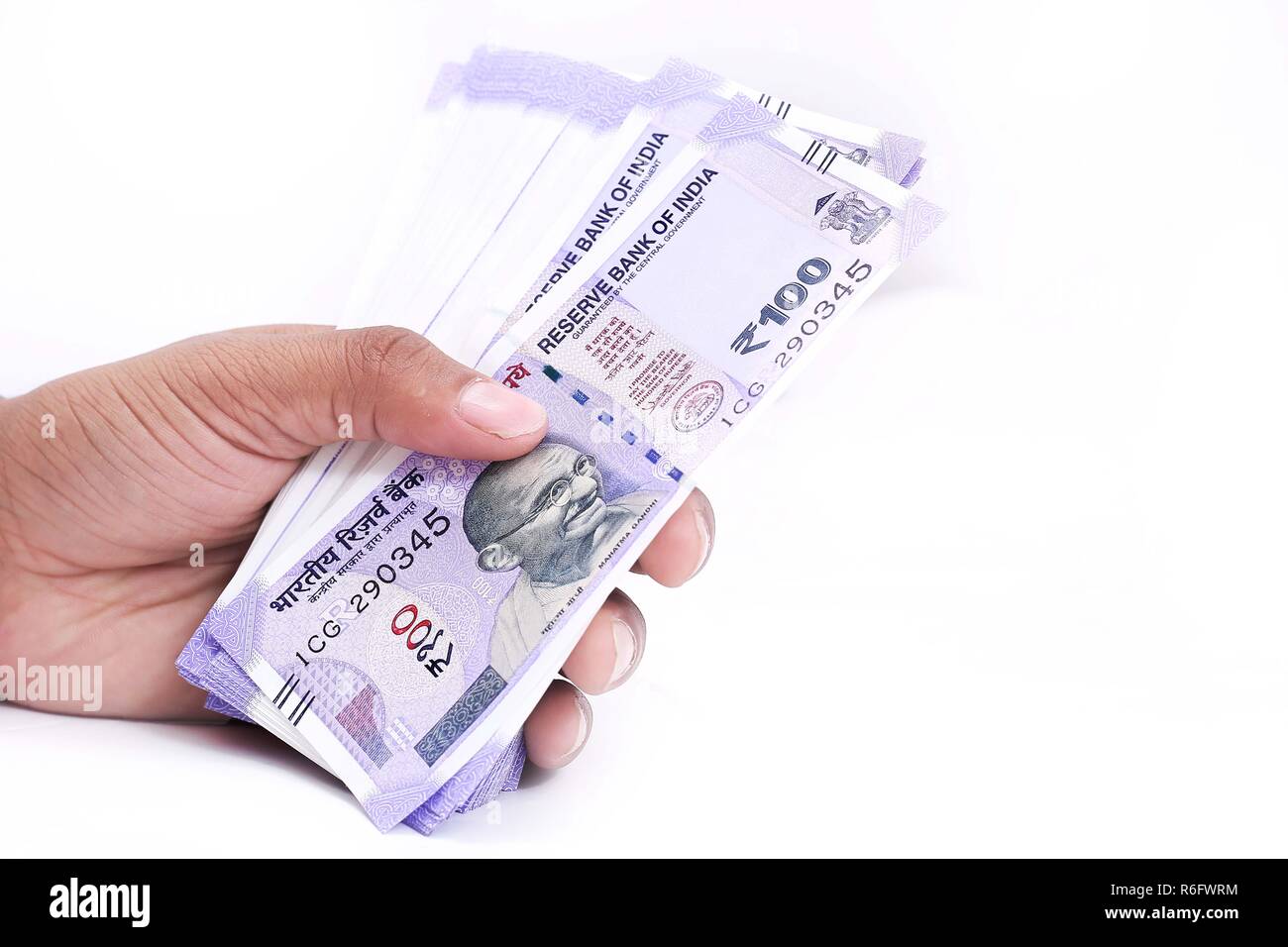 Picture of hand with new Indian currency notes. Isolated on the white ...