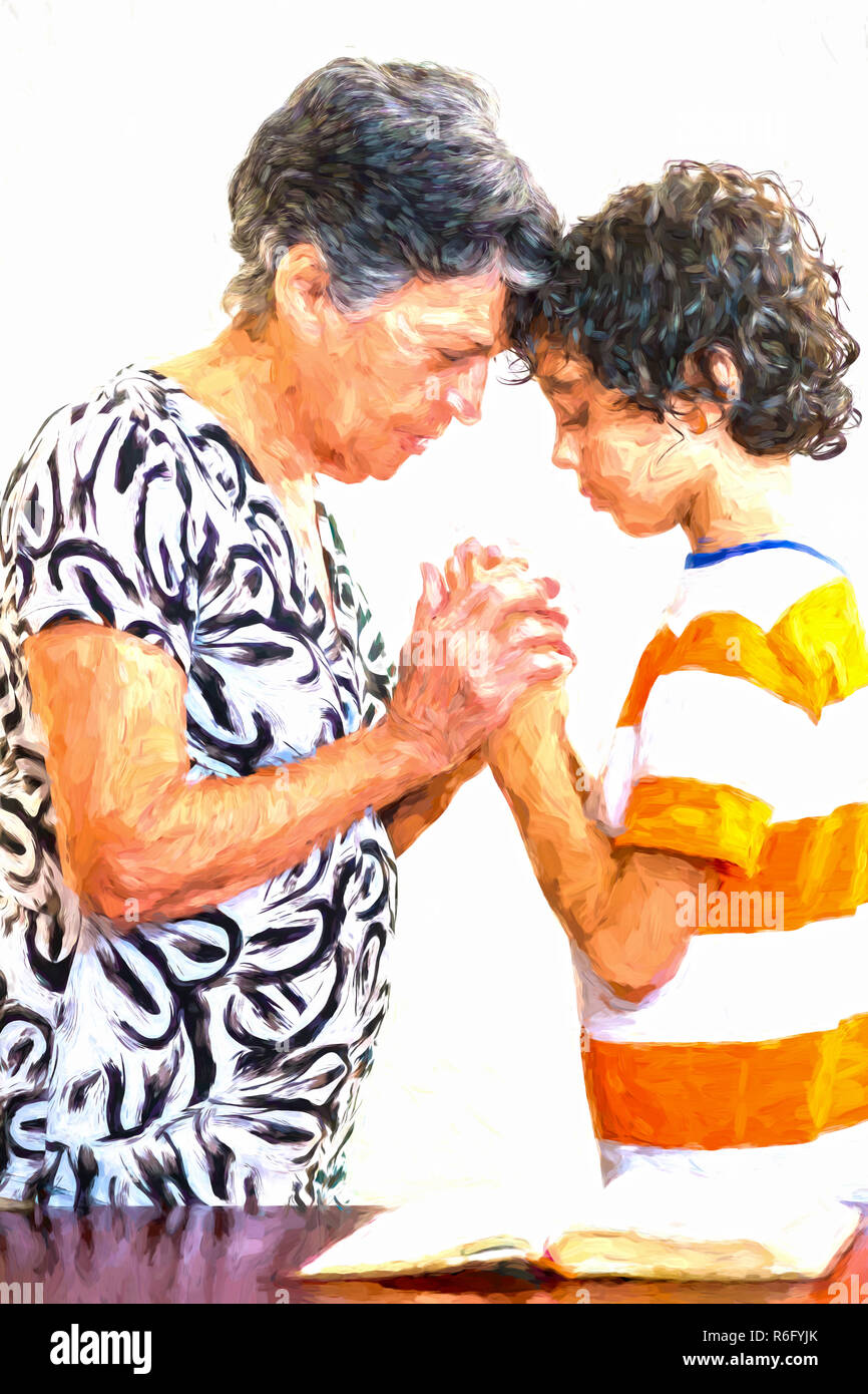 Grandmother and grandson praying together in their daily Christian devotional. Hispanic family practising their faith in Jesus and in God praying toge Stock Photo