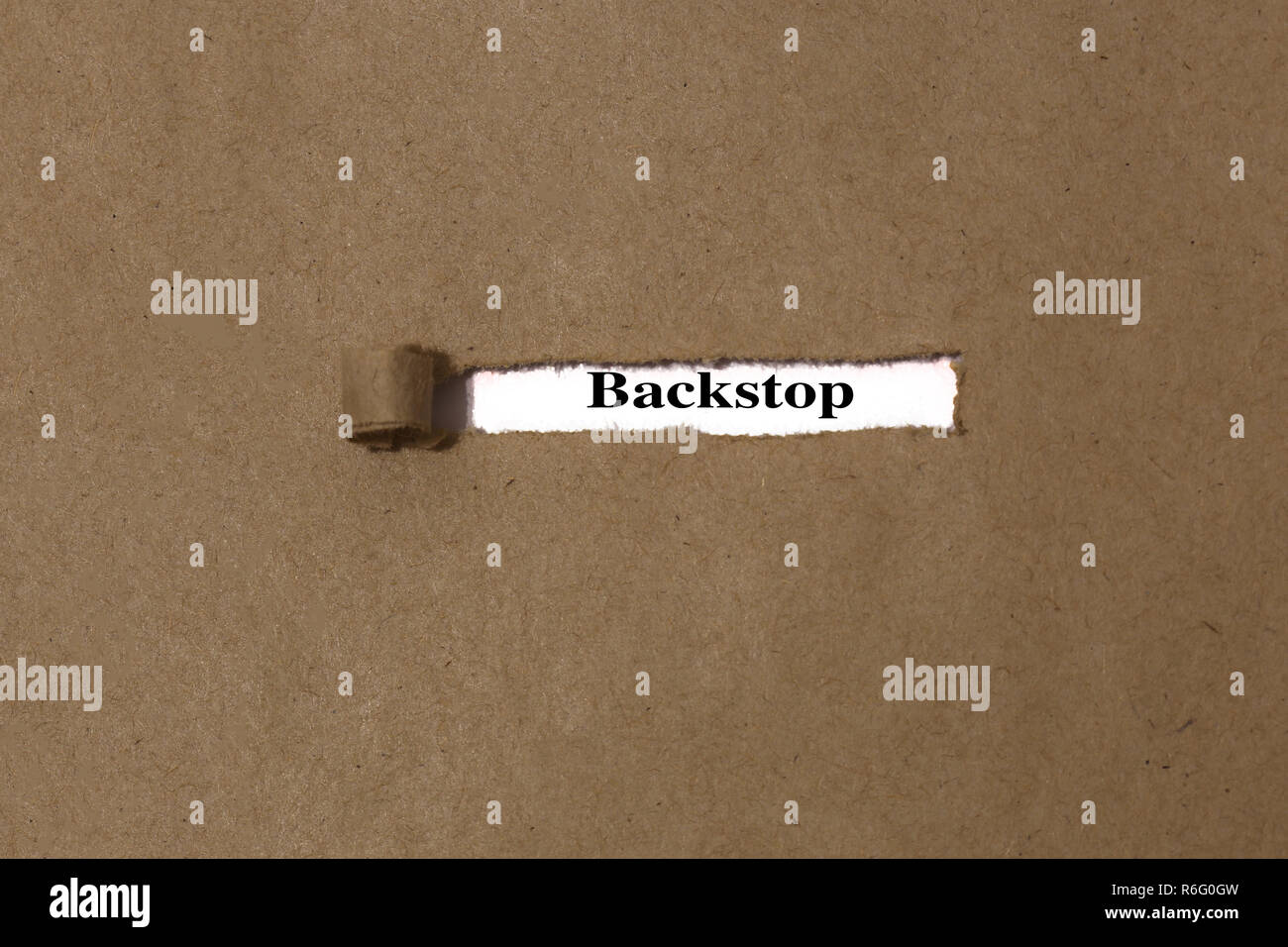 Ripped brown manilla envelope revealing the word backstop on white