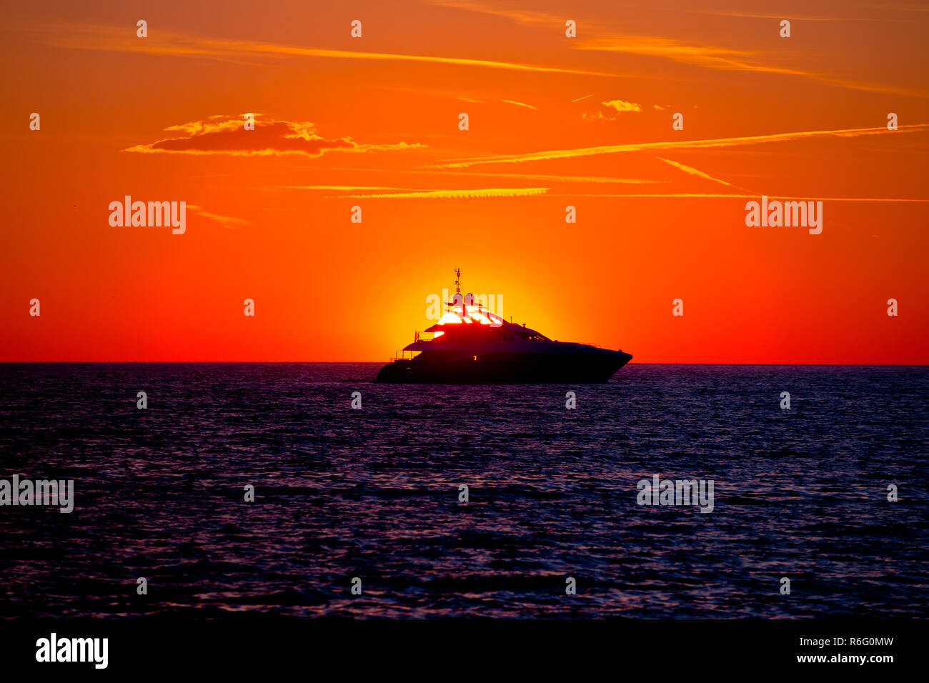 Luxury yacht on open sea at golden sunset Stock Photo - Alamy