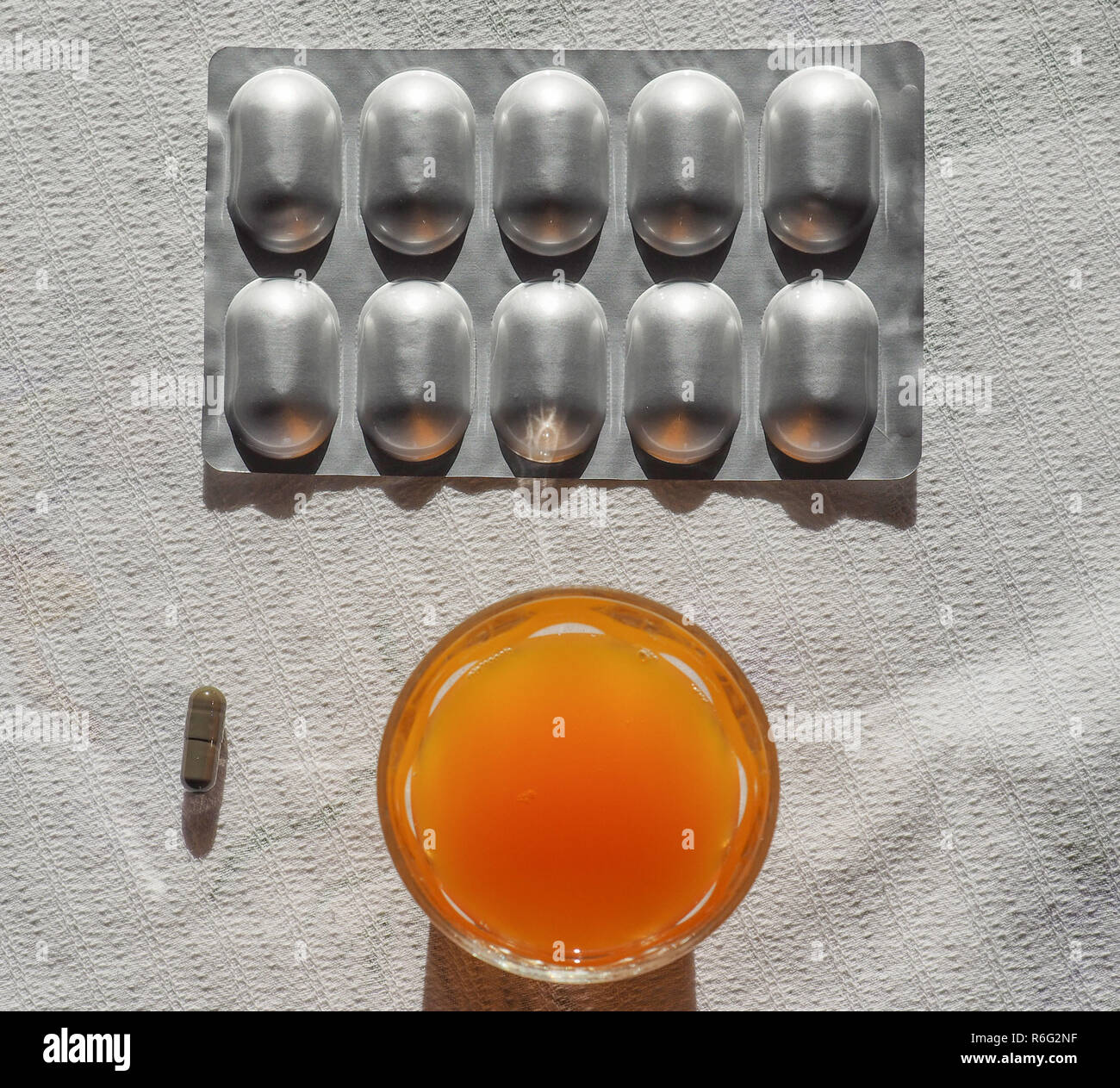 Iron supplements and orange juice Stock Photo Alamy