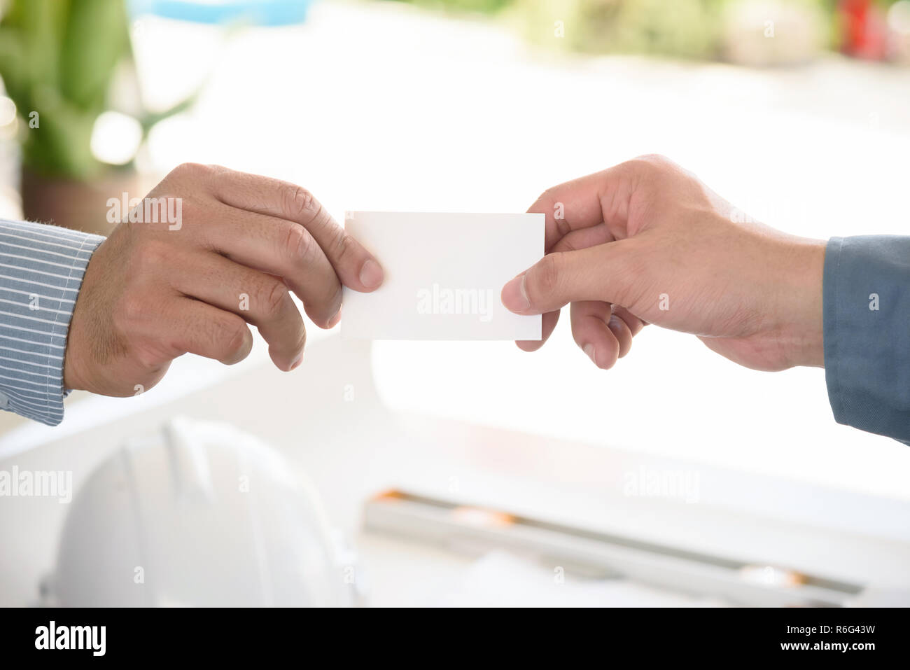 exchanging business card with engineering tools background Stock Photo