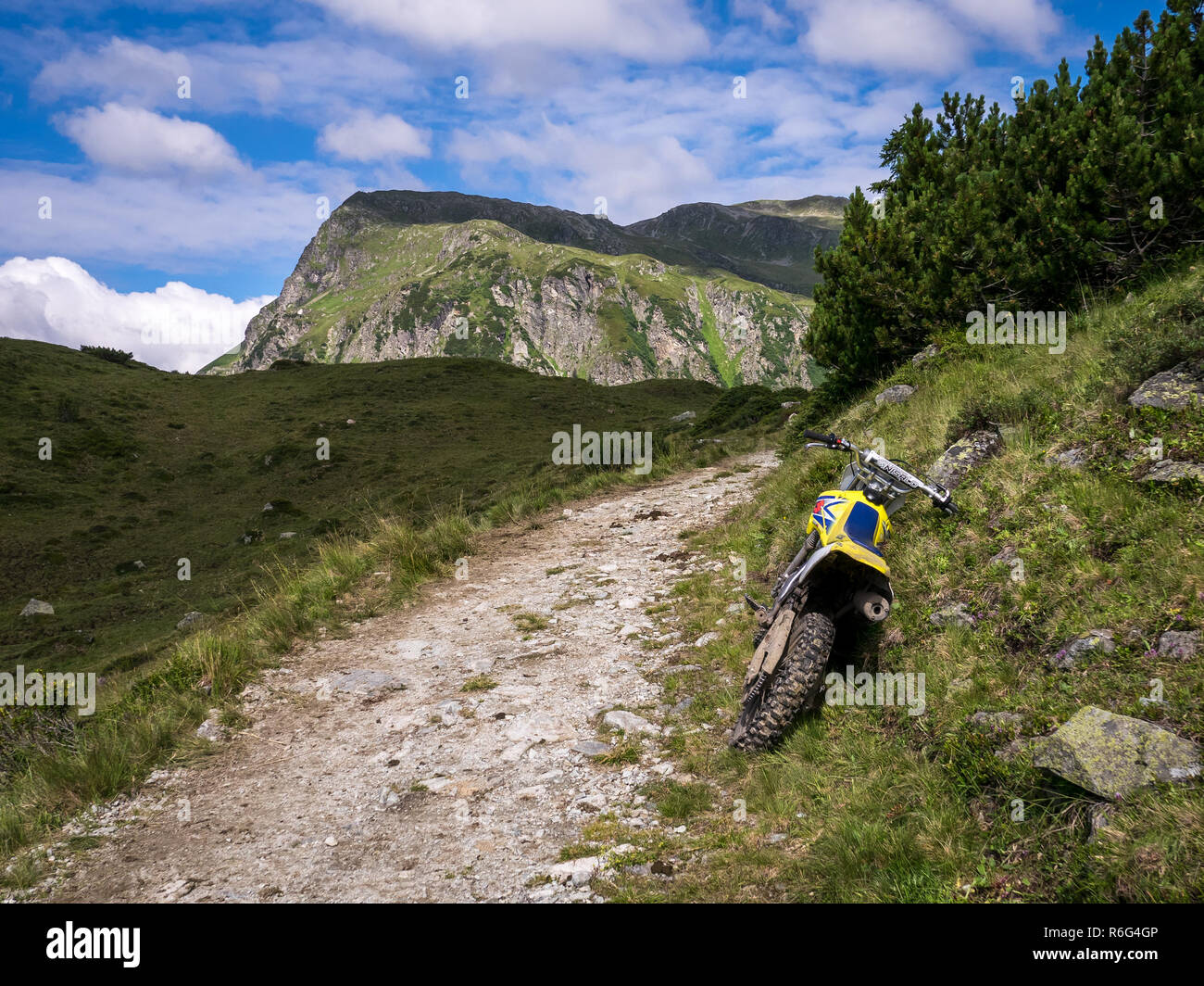 A motocross motorbike laid down on the wayside of a mountain track in Montafon, Vorarlberg, Austria Stock Photo