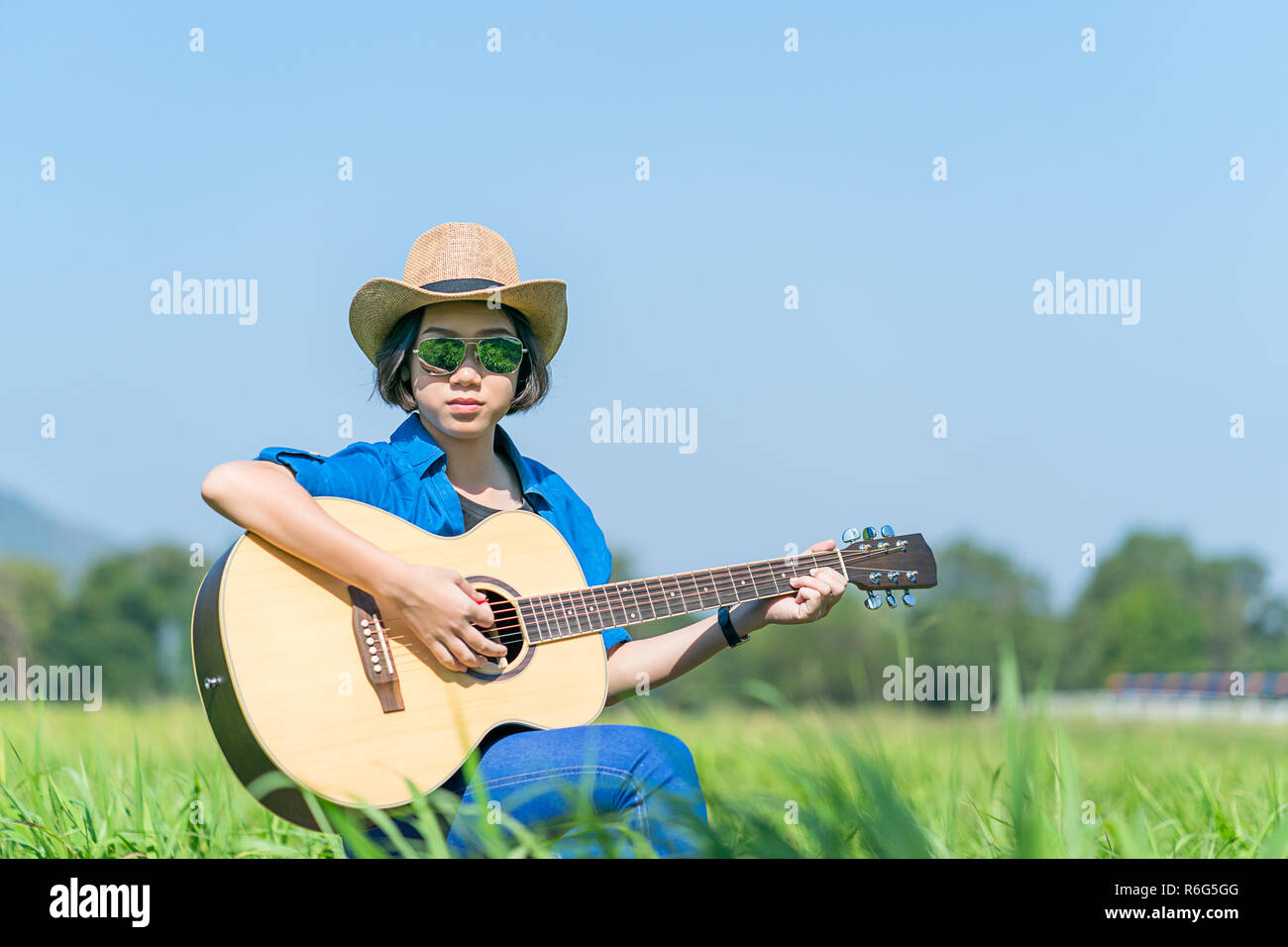 Women Short Hair Wear Hat And Sunglasses Sit Playing Guitar In