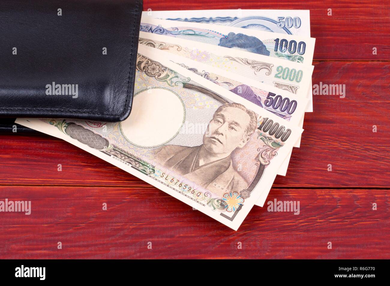 Japanese money in the black wallet Stock Photo Alamy