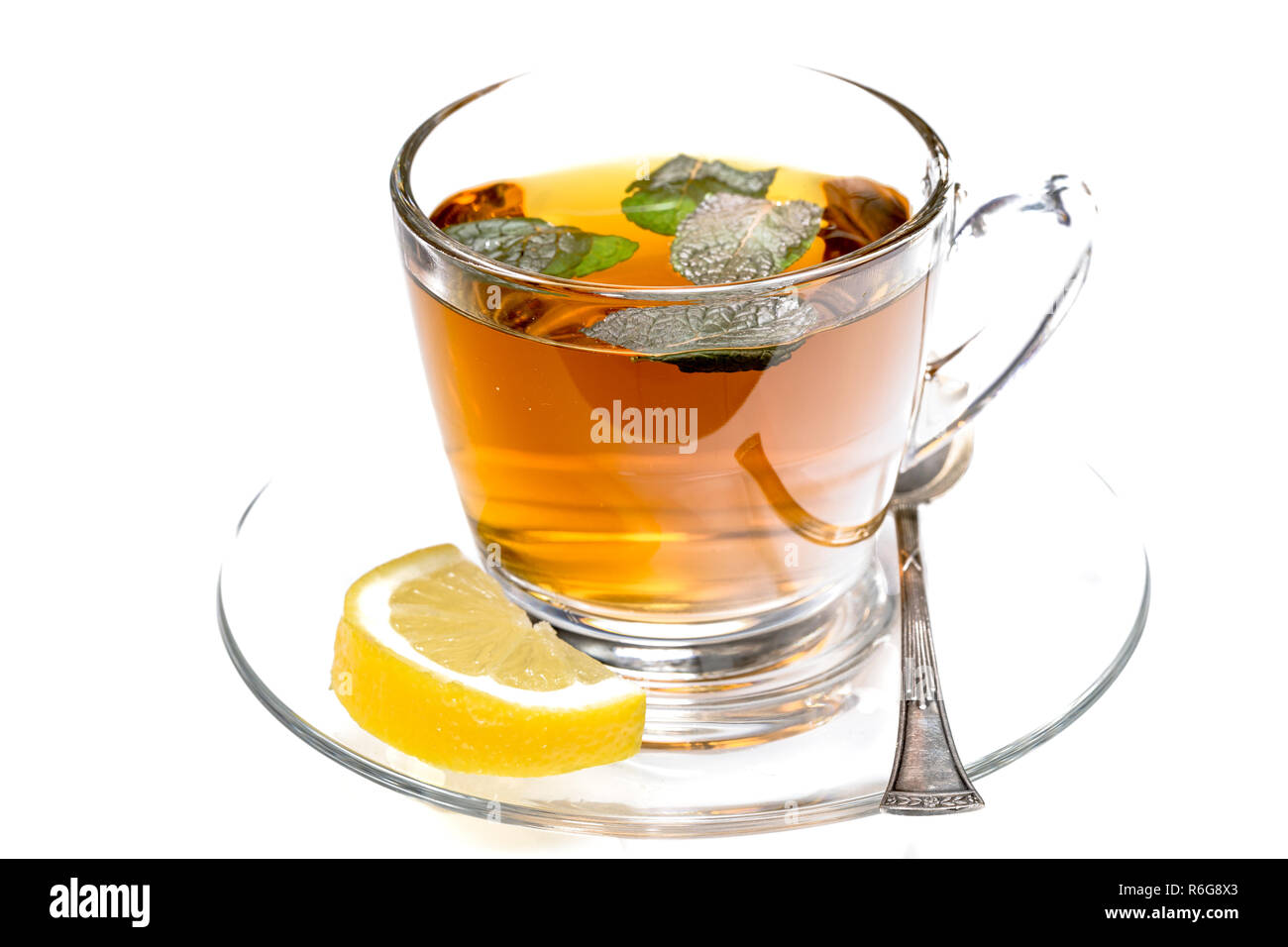 glass of mint tea with fresh mint and lemon isolated on white