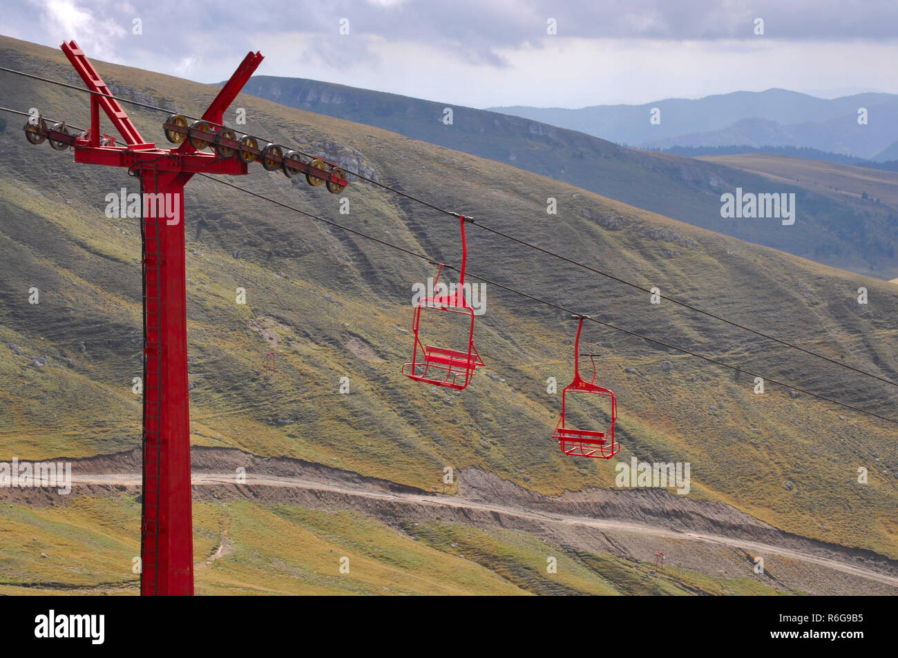 Old red ski chair lifts in summer mountains Stock Photo - Alamy