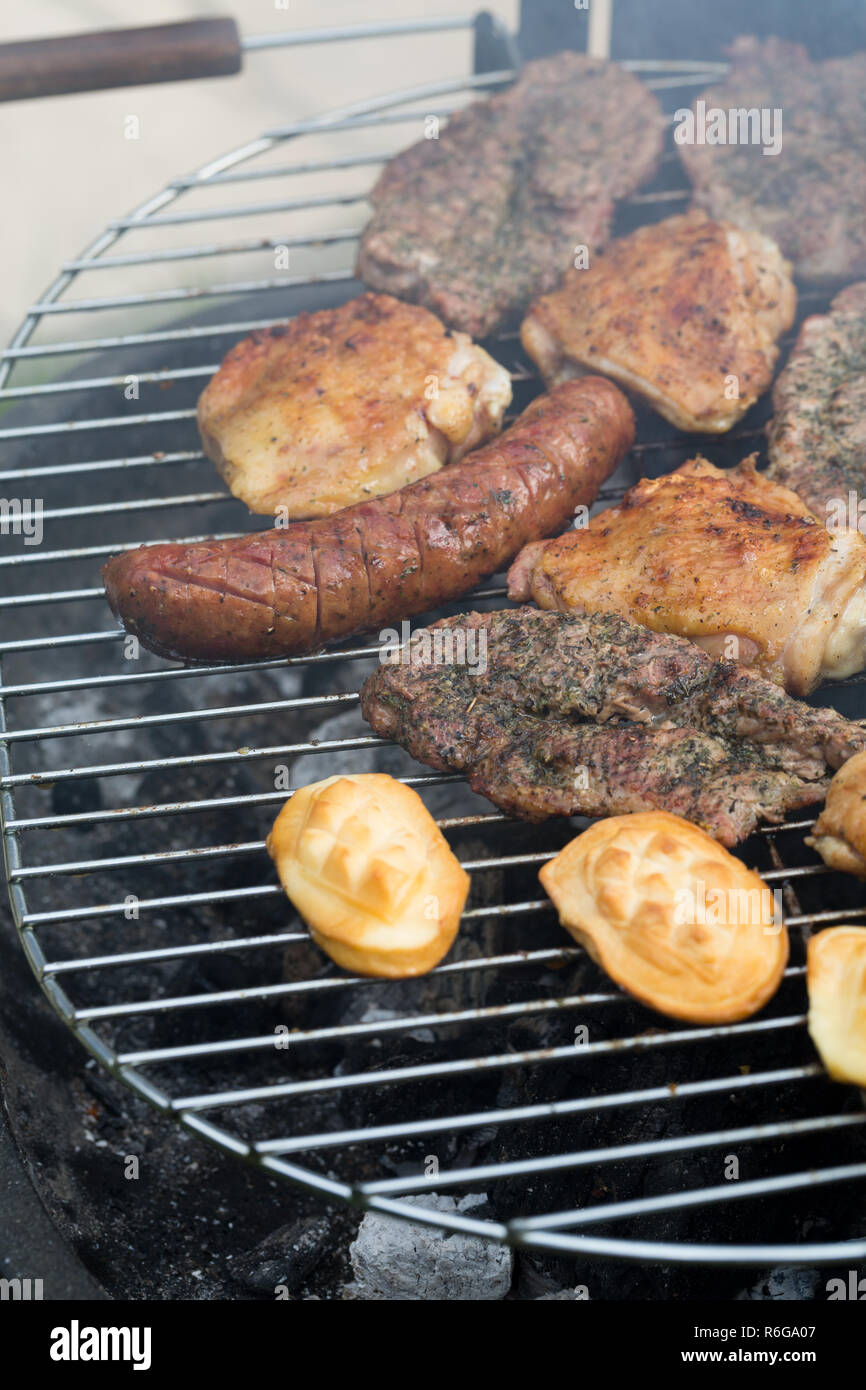barbecue with delicious grilled meat and vegetables on grill Stock ...