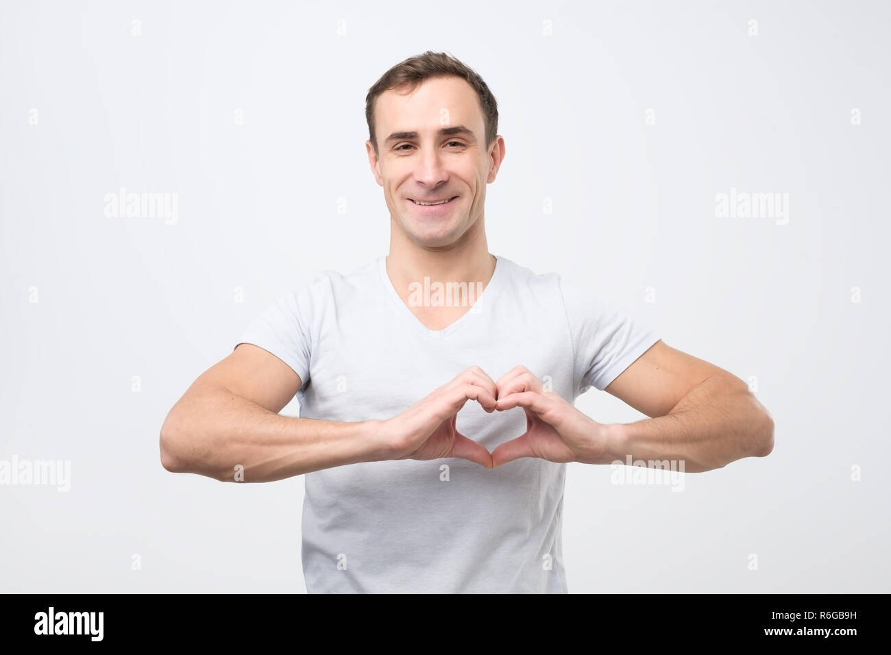 Mature italian man making out of hands heart. Doing charity work Stock Photo