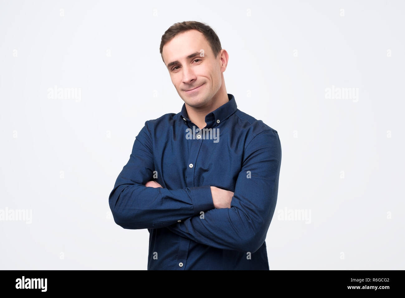 Happy man standing arms crossed hi-res stock photography and images - Alamy