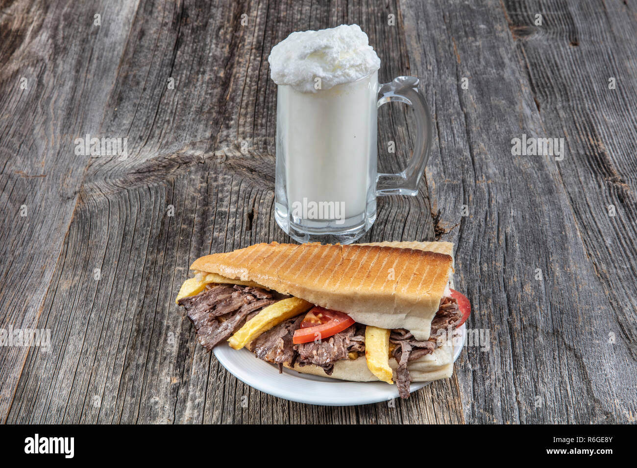 Doner kebab with meat, vegetables and french fries close-up on the table. Ayran Stock Photo