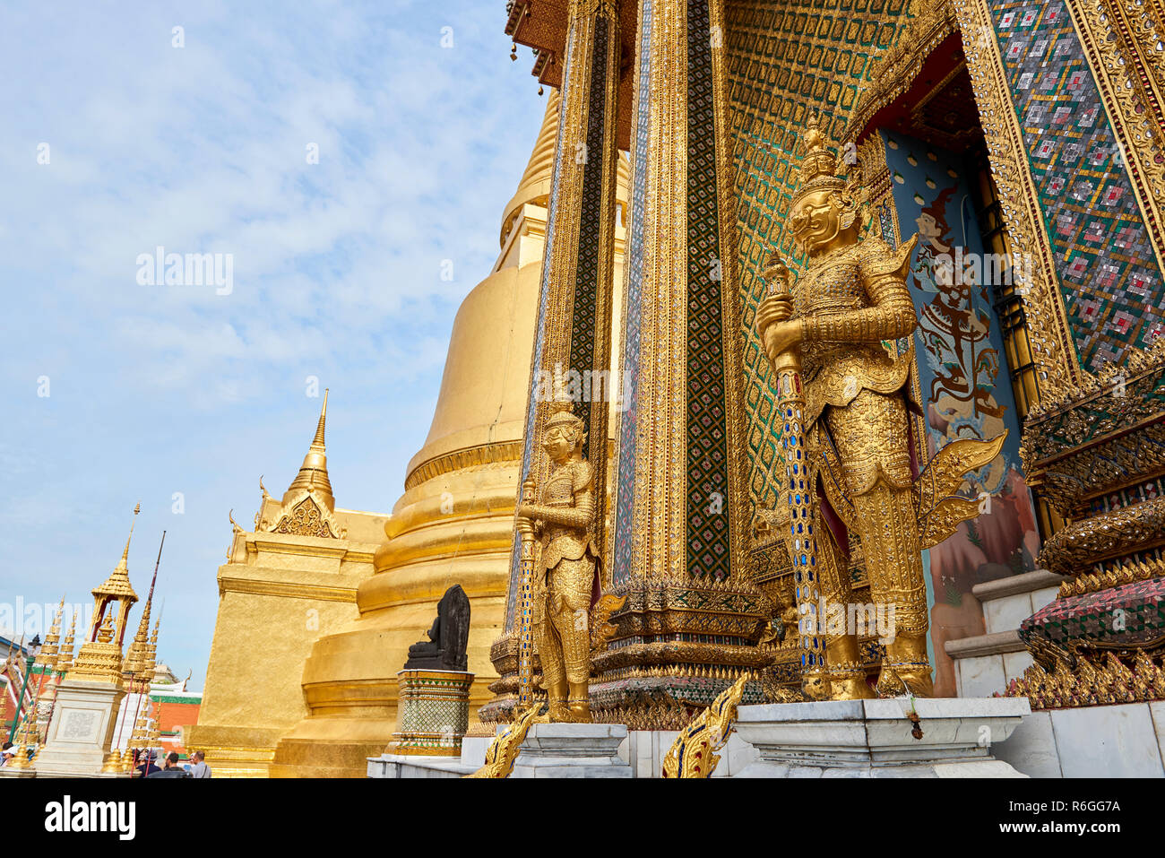 Golden Yaksha statue in the Grand Palace in Bangkok, Thailand. The demon-gods statues are a common sight in Buddhist temples in Thailand, but also fea Stock Photo