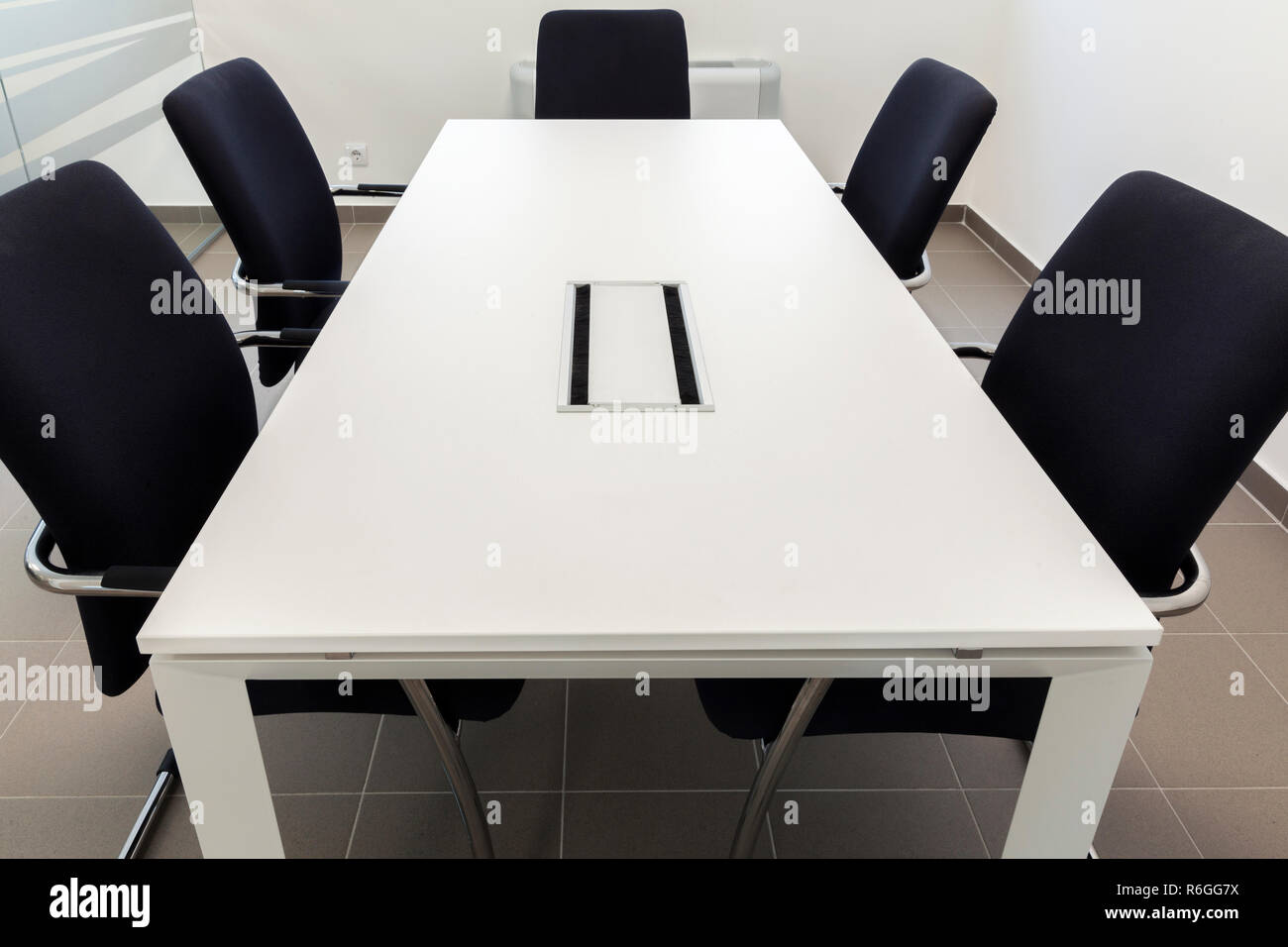 small conference room, white table and black chairs Stock Photo Alamy