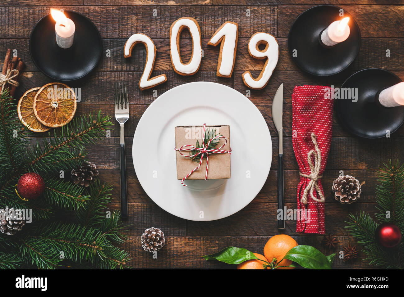 Table Setting Authentic New Year 2019 on rustic wooden table background. Minimalistic table setting top view Stock Photo