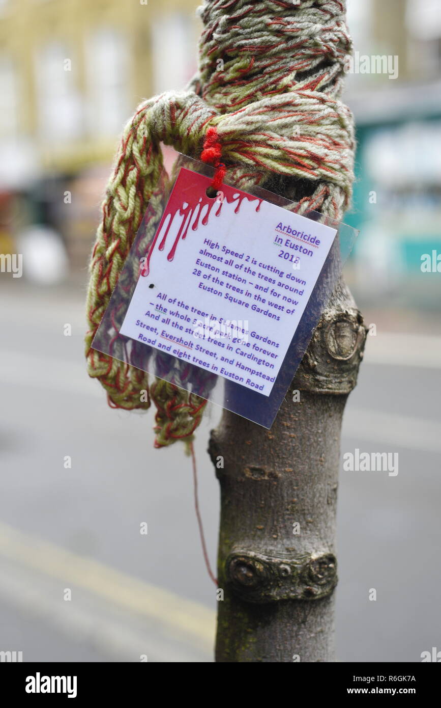 Protest against the cutting down of trees with the HS2 High Speed 2 railway development plans. "Arboricide in Euston 2018" - sign and wool knitting Stock Photo