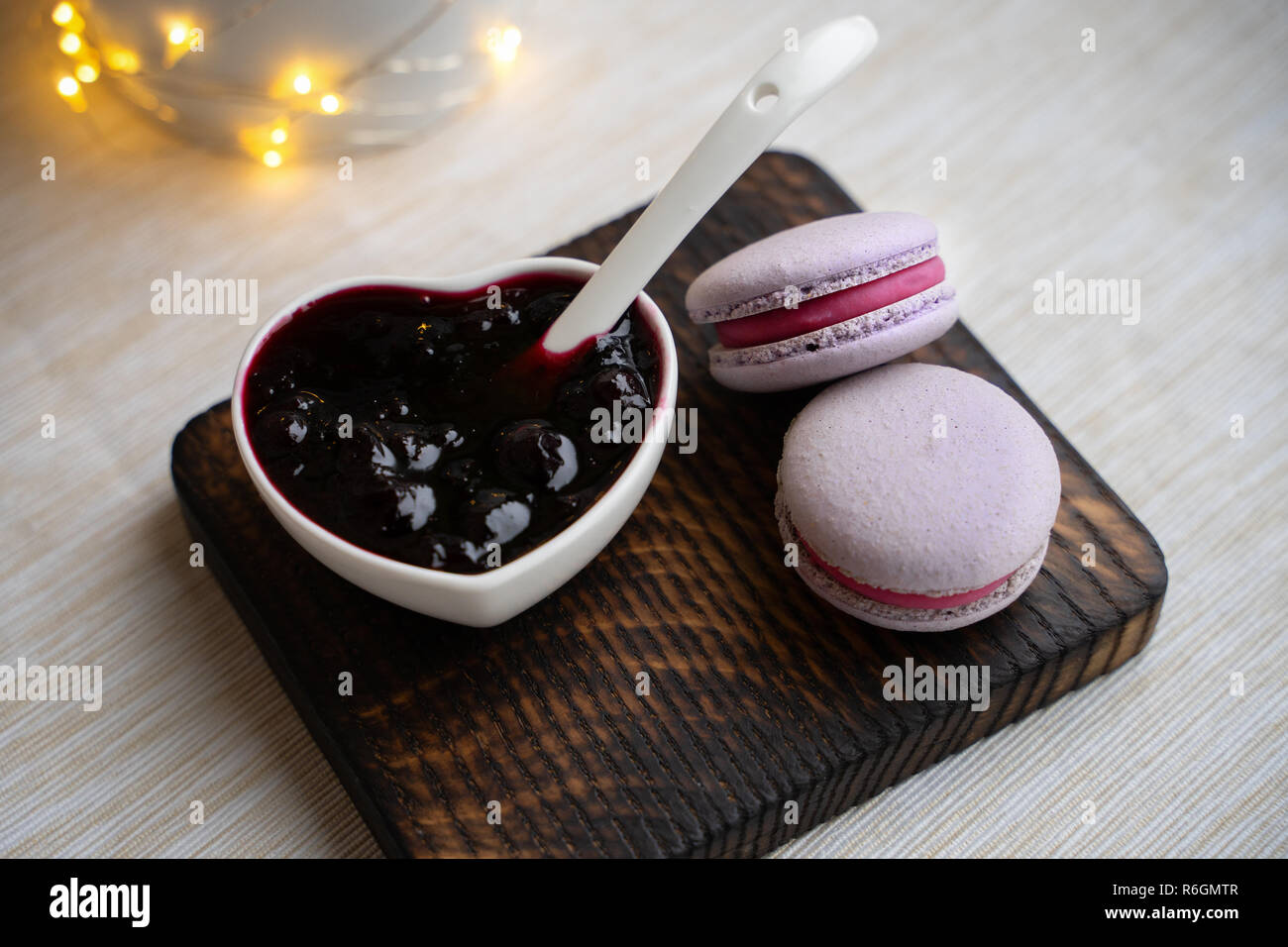 macaroons with currants on a white plate with jam Stock Photo