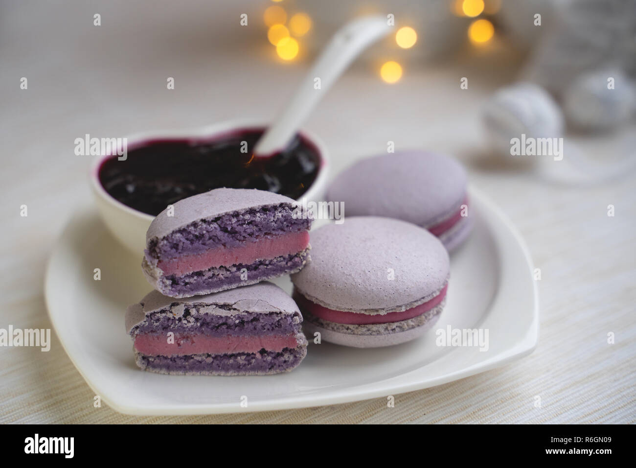 macaroons with currants on a white plate with jam Stock Photo