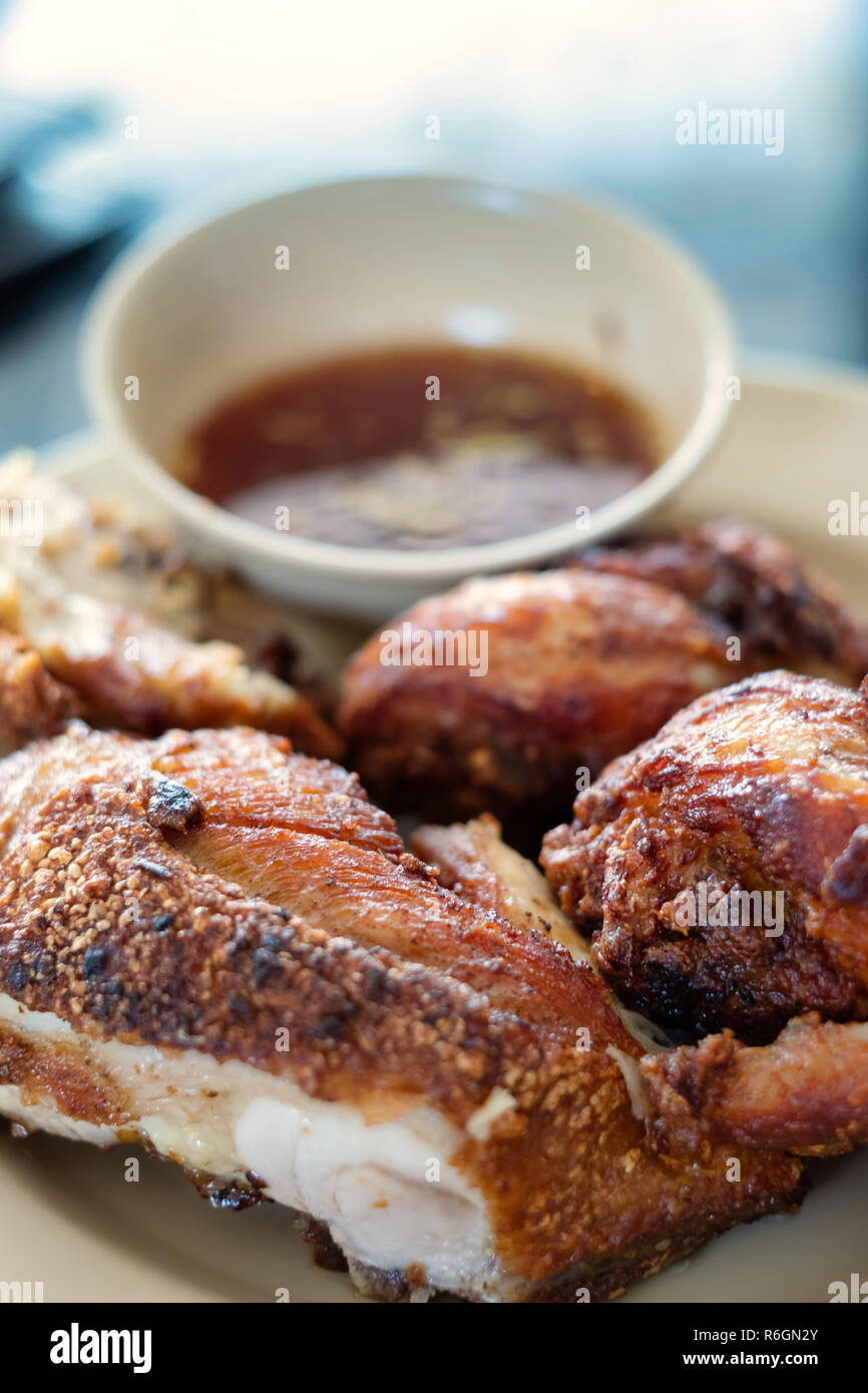 Fried chicken with spicy source in Thai menu style is served ready to be eaten. Stock Photo