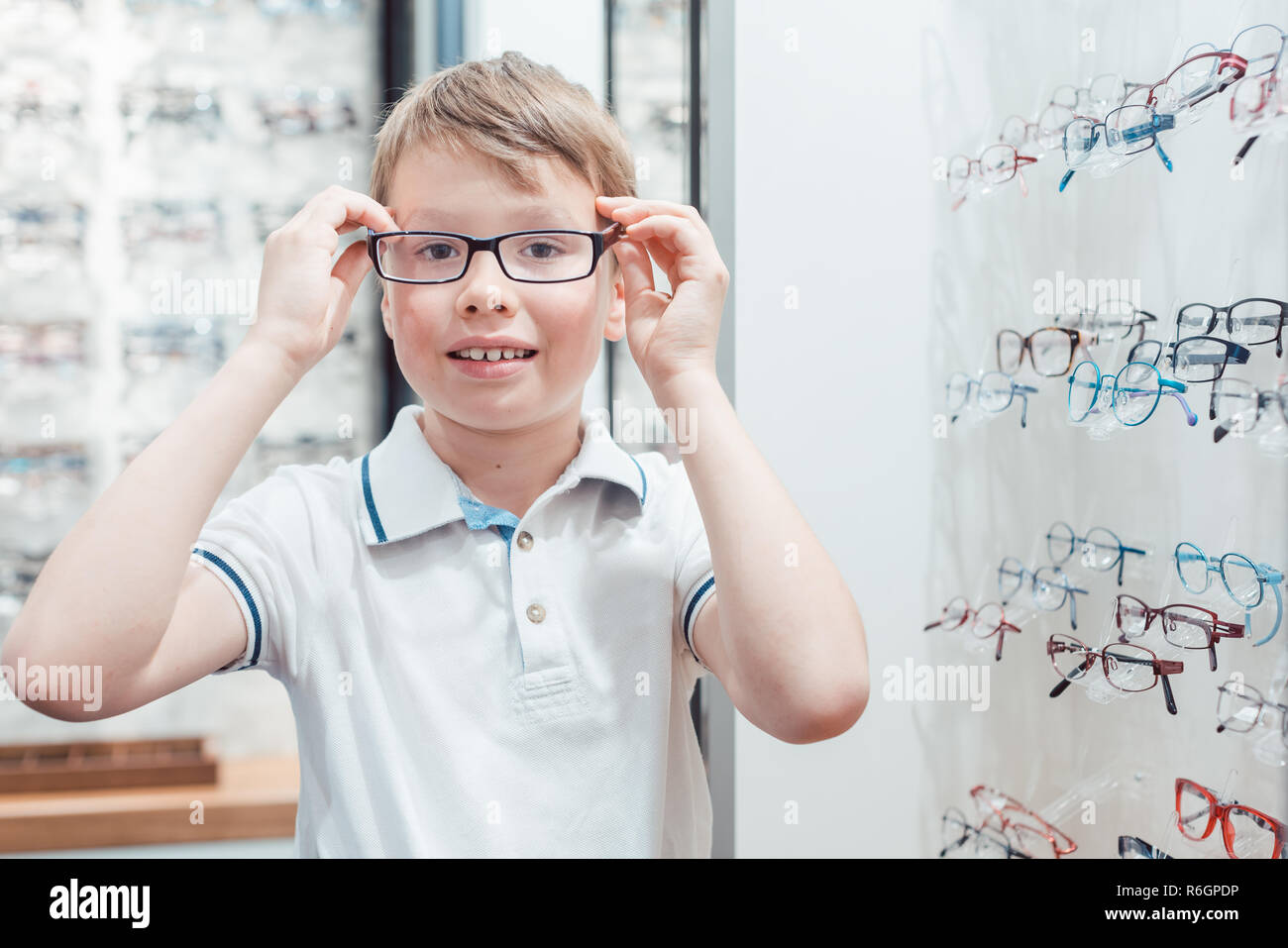Young boy being very happy with his new eyeglasses in the store Stock Photo