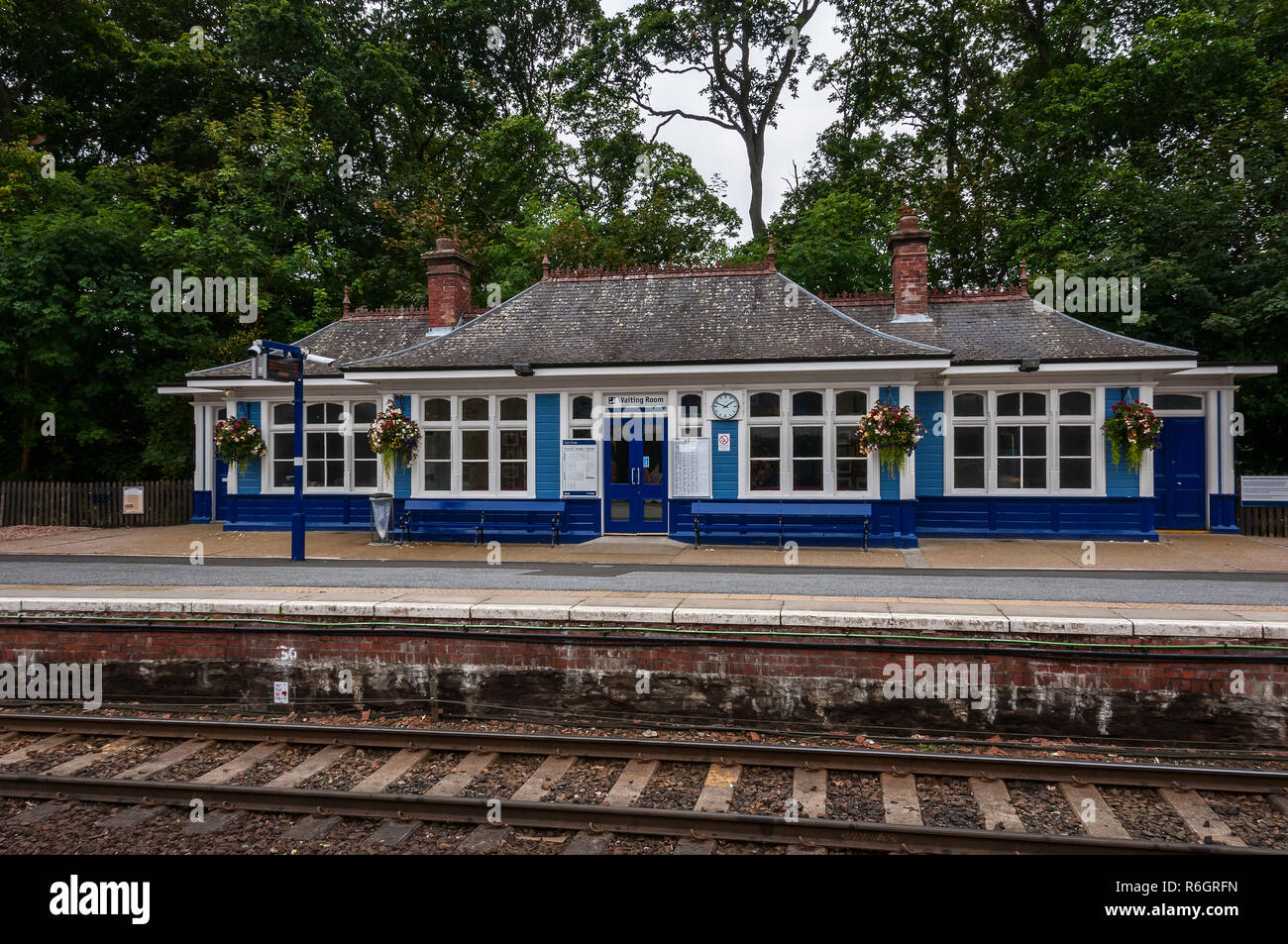 The single storey weather boarded blue and white painted pavilion style waiting rooms consisting of a central portion with two set- back wings Stock Photo
