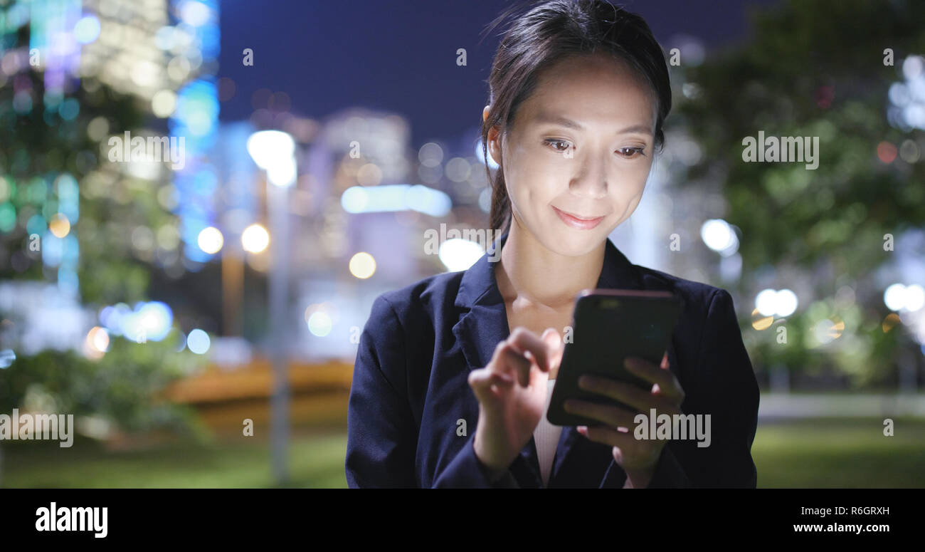 Business woman working on smart phone at night Stock Photo - Alamy