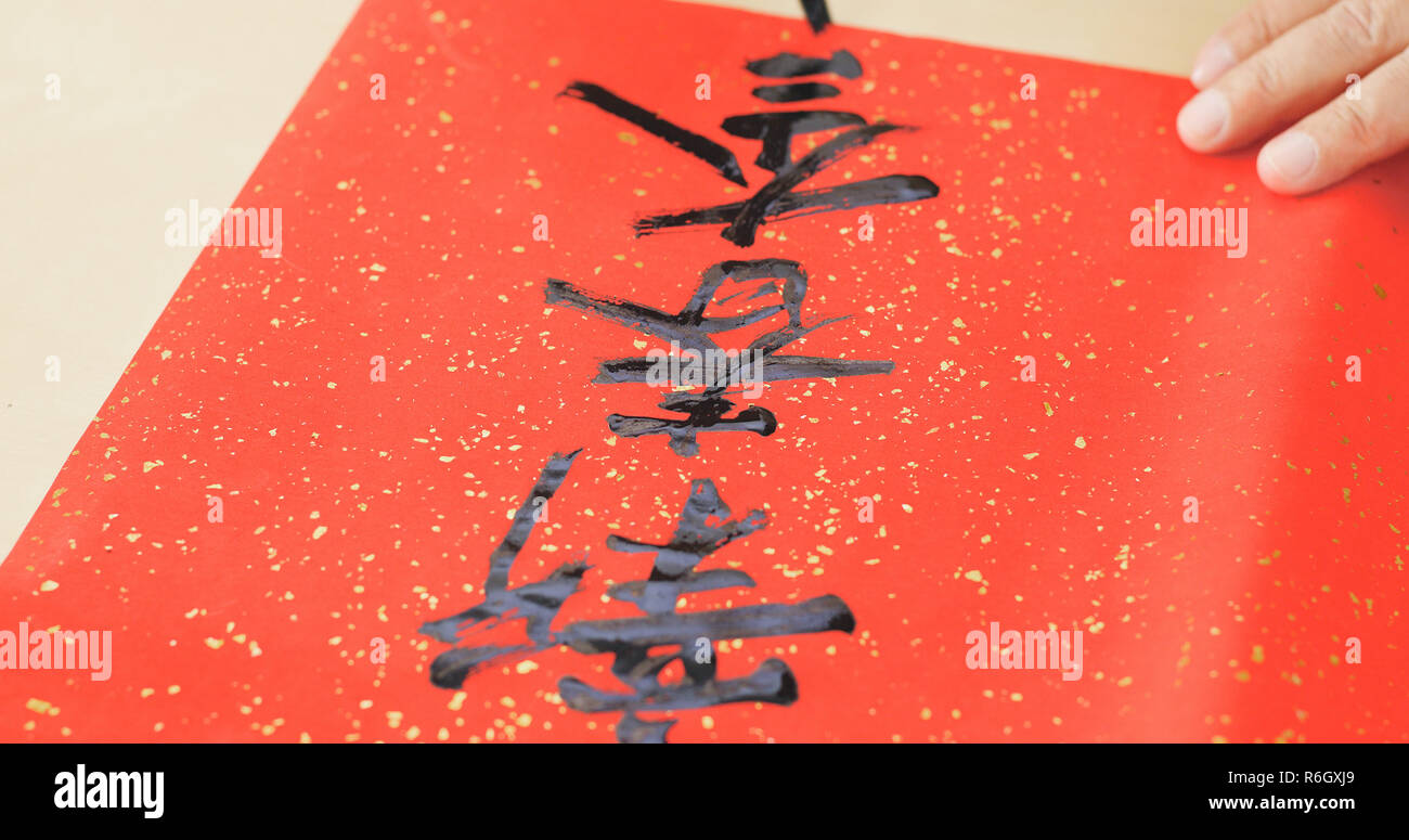 Writing Chinese calligraphy on write paper with phrase meaning