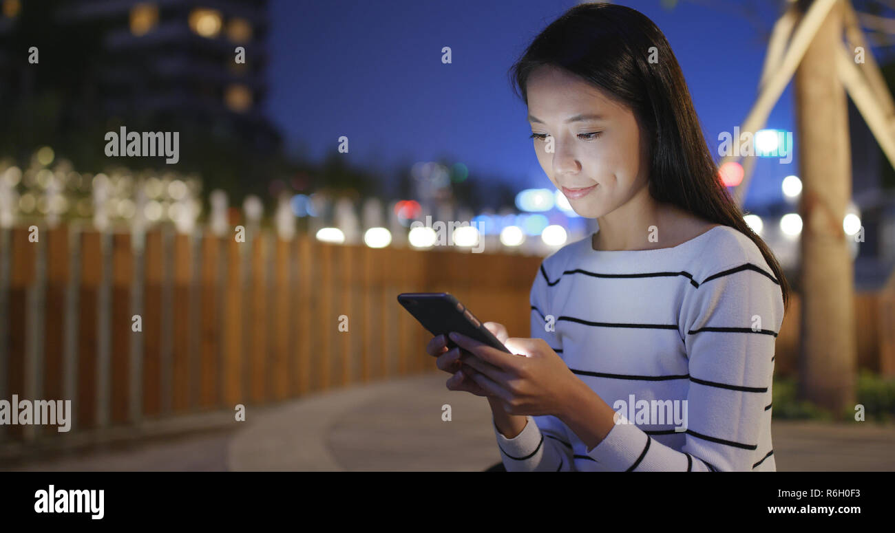 Woman use of smart phone in Hong Kong at night Stock Photo - Alamy