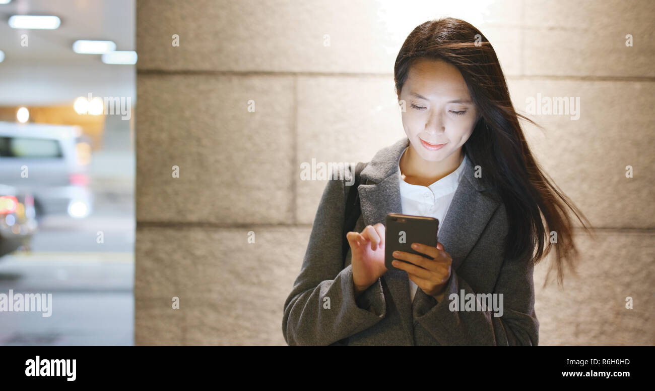 Asian business woman use of mobile phone at night Stock Photo - Alamy