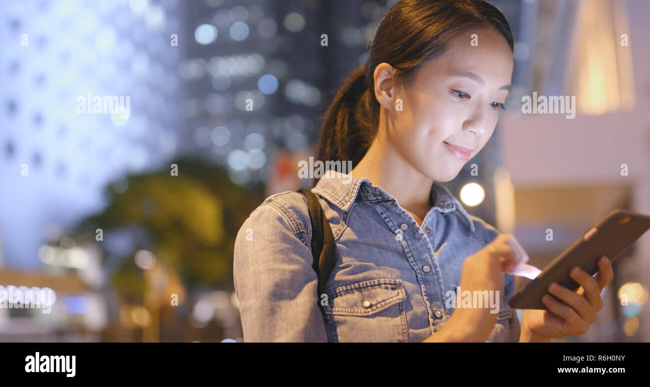 Woman using mobile phone in Hong Kong at night Stock Photo - Alamy