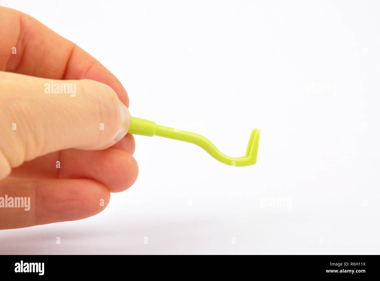 Hand with tick tweezers on white background Stock Photo Alamy