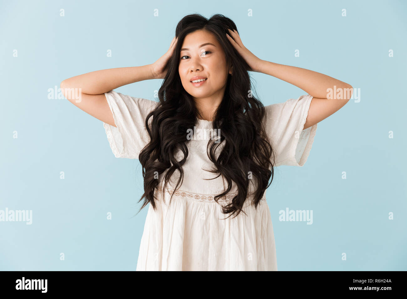 Image of happy young asian beautiful woman posing isolated over blue ...
