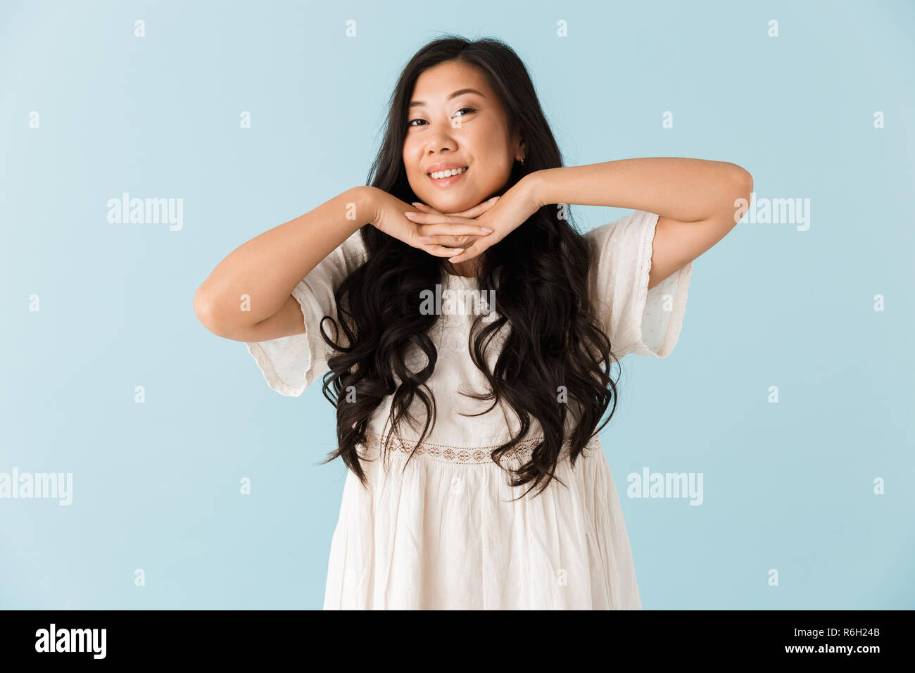 Image of happy young asian beautiful woman posing isolated over blue ...
