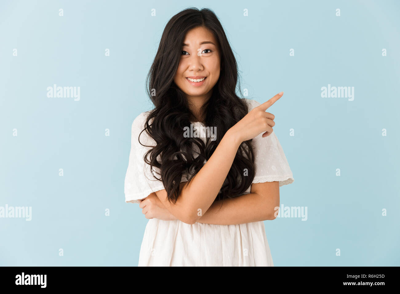 Image of happy young asian beautiful woman posing isolated over blue ...