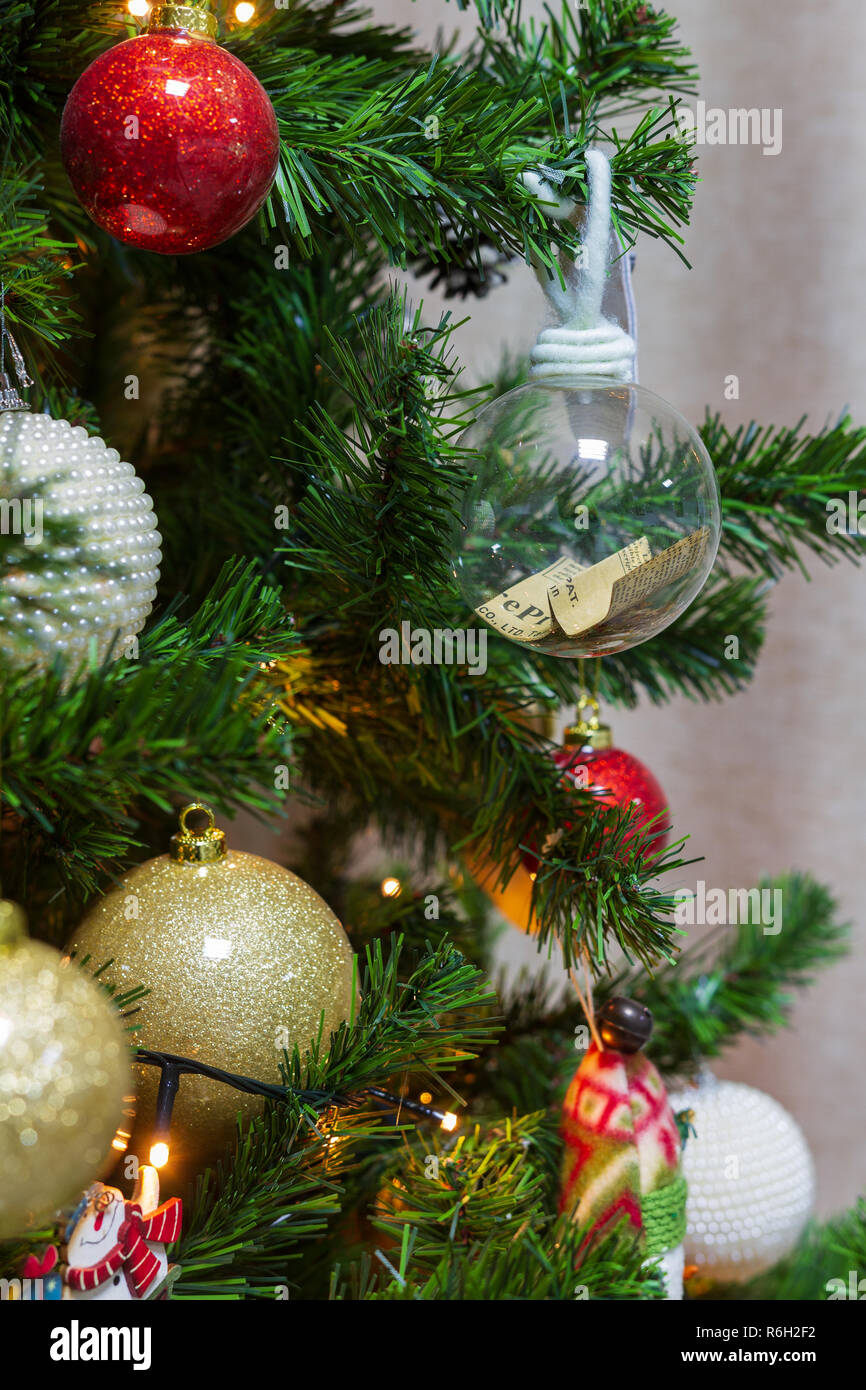 Close Up On A Christmas Tree Of Hanging Decorative Items Including