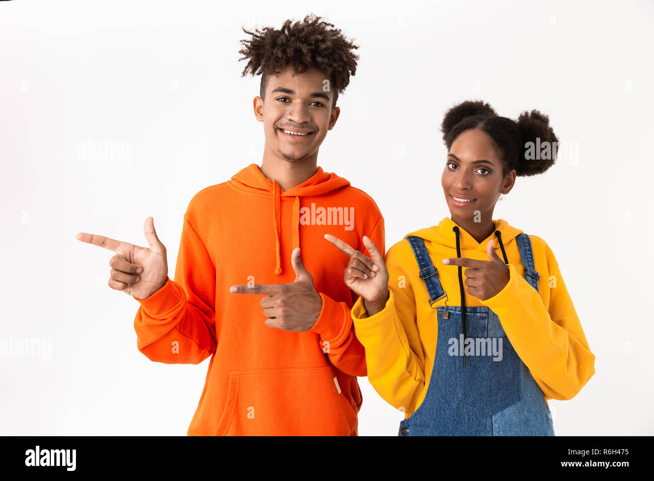 Portrait of a two cheerful young african couple isolated over white ...