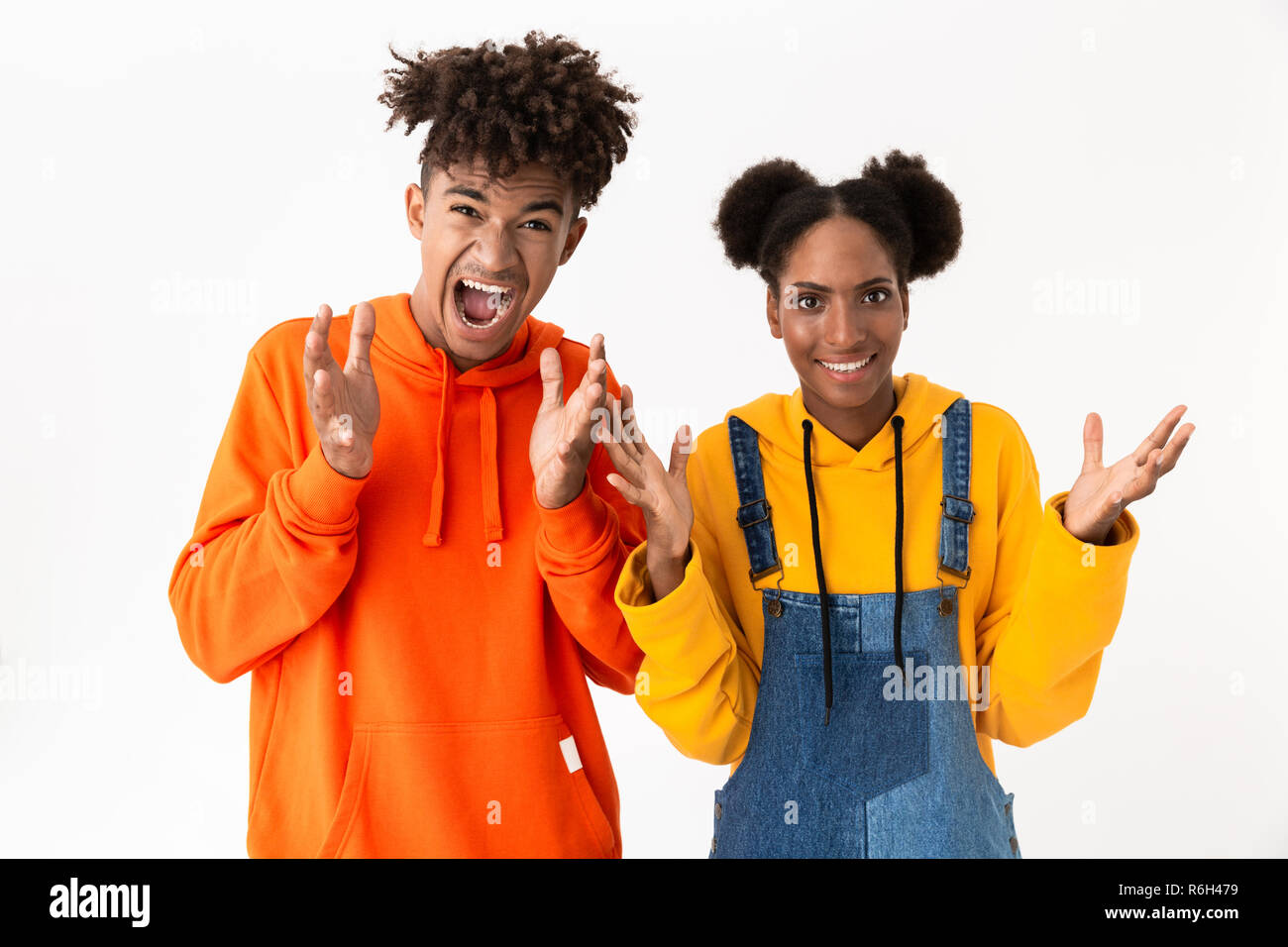 Portrait of a two confused young african couple isolated over white ...