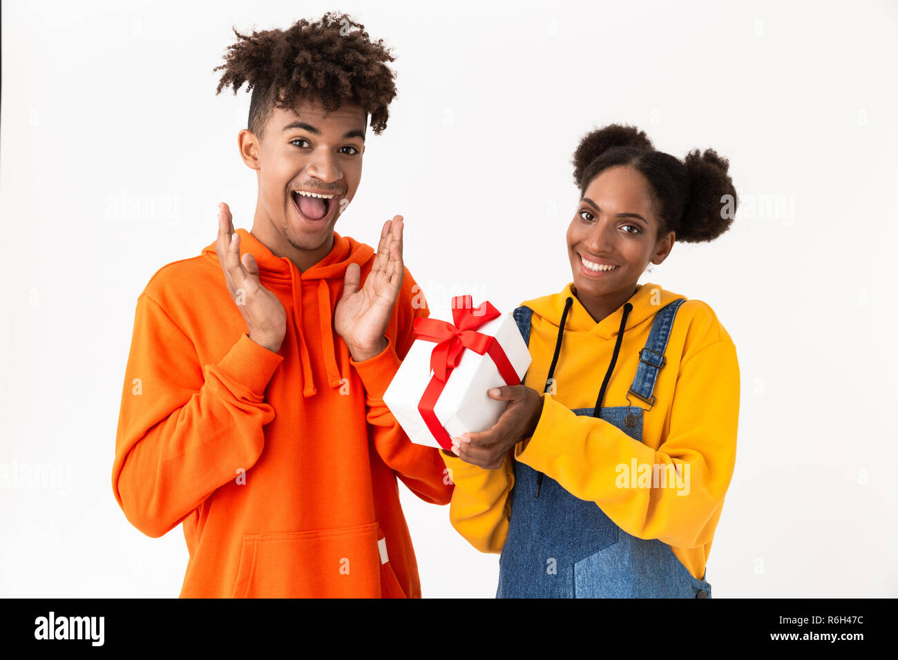 Portrait of a two cheerful young african couple isolated over white ...