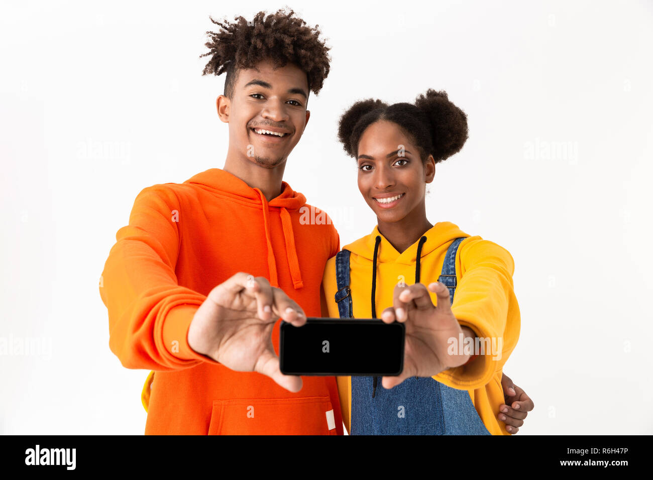 Portrait of a two smiling young african couple isolated over white ...
