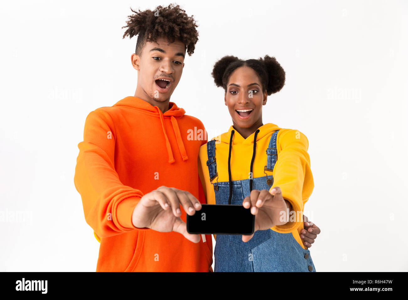 Portrait of a two cheerful young african couple isolated over white ...