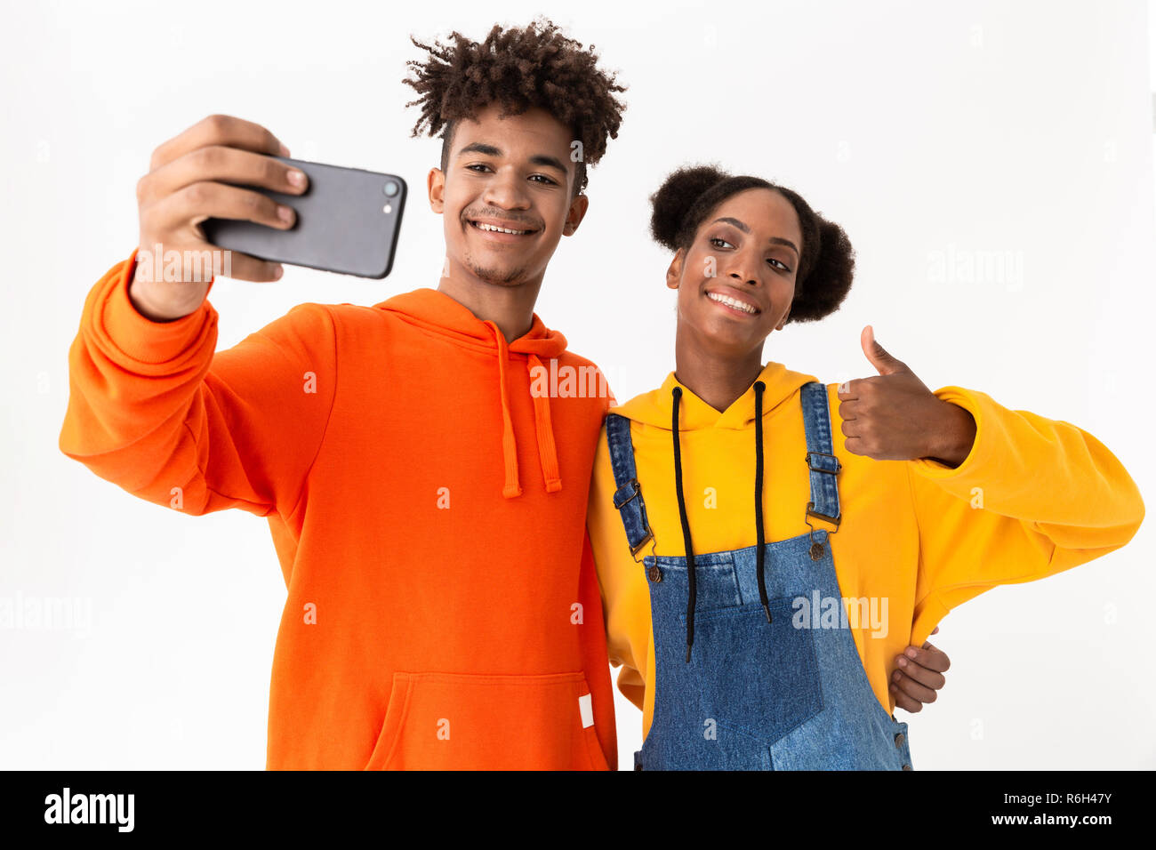 Portrait of a two cheerful young african couple isolated over white ...
