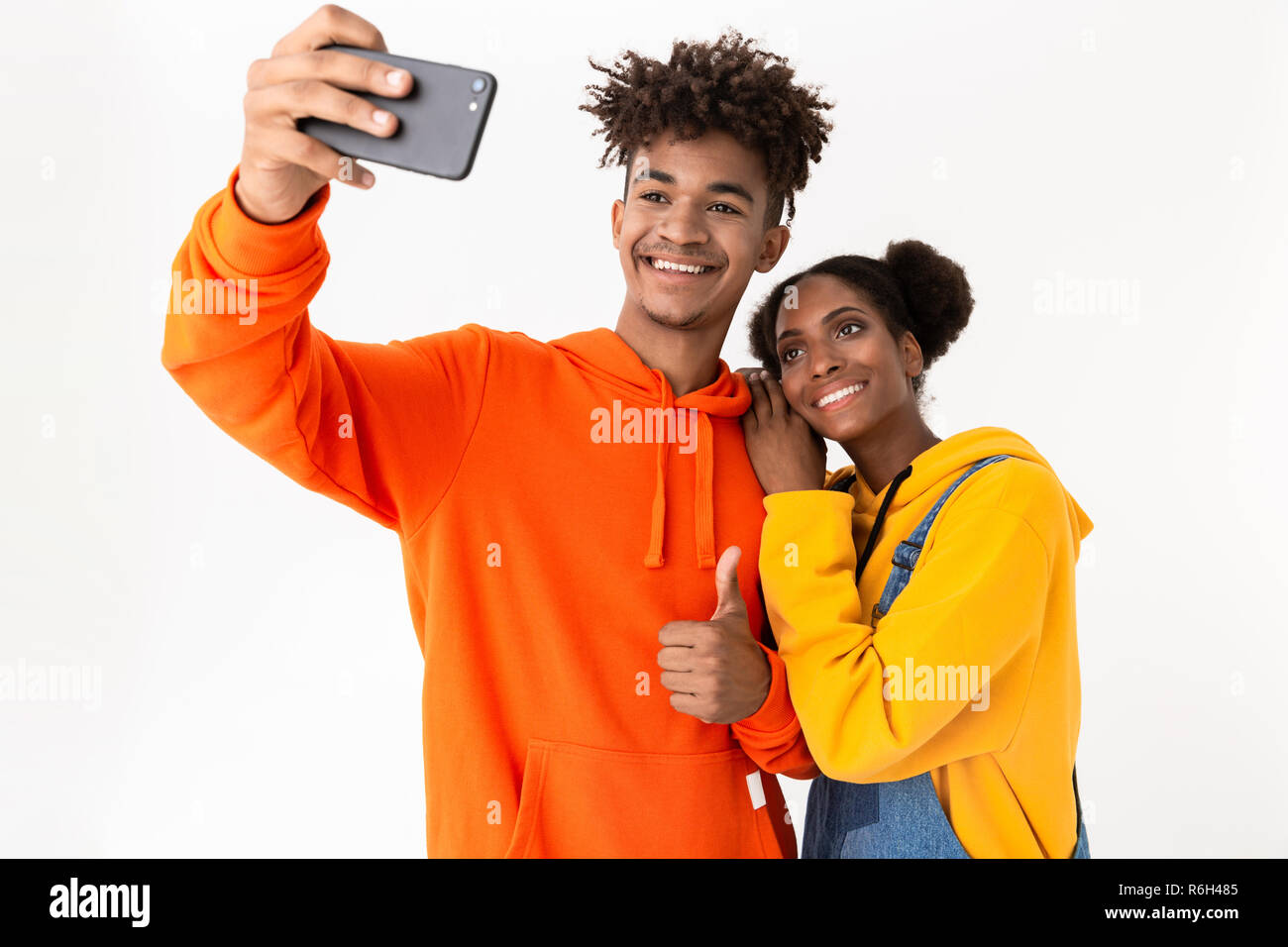 Portrait of a two smiling young african couple isolated over white ...
